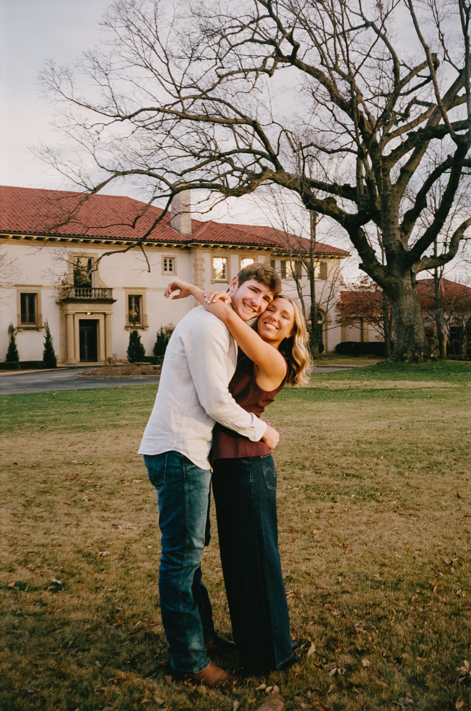 Couple sharing a joyful moment while dancing outside a Spanish-style building.