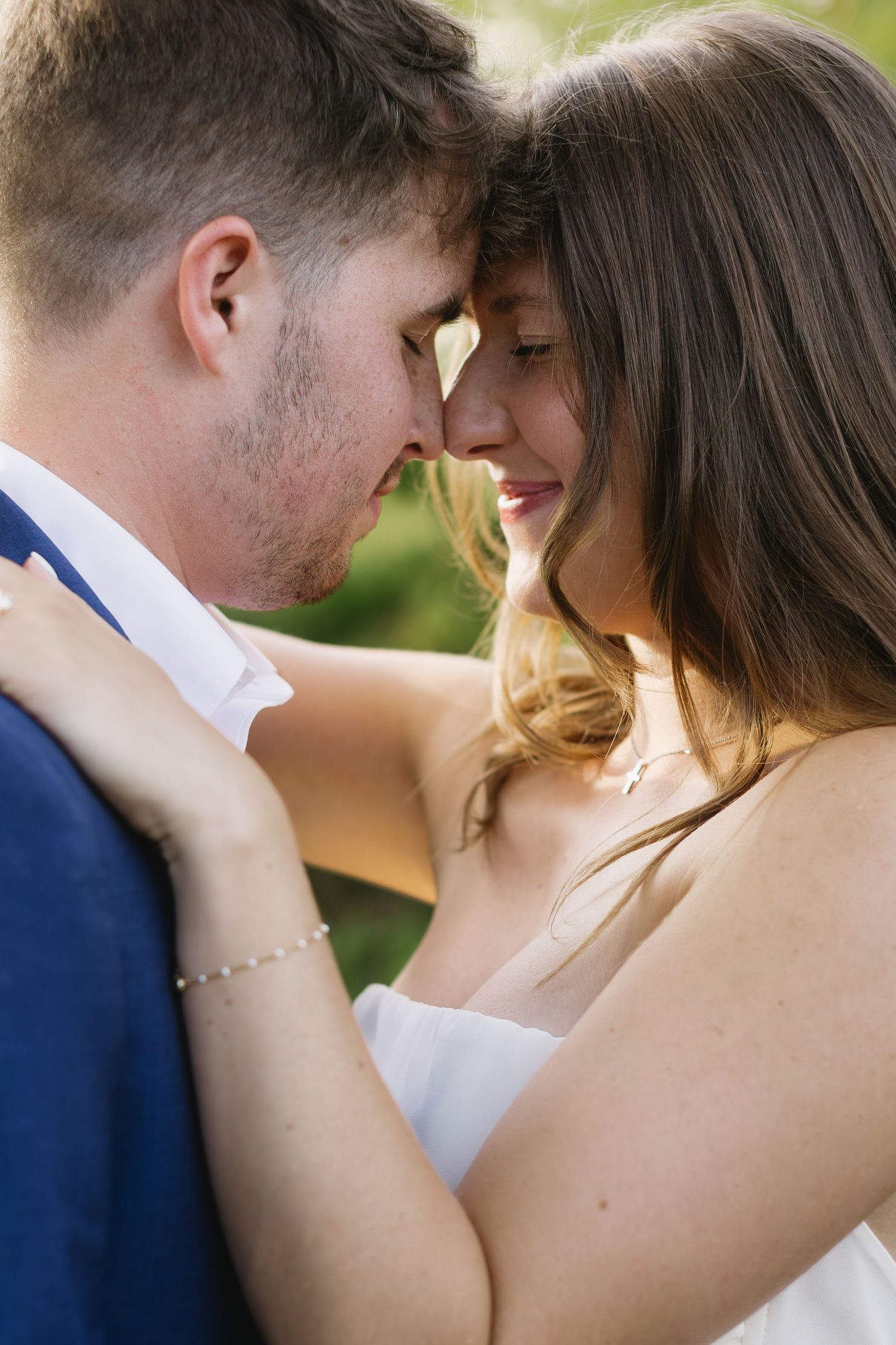 A series of romantic wedding photos showing tender closeup moments between a couple in formal attire outdoors.