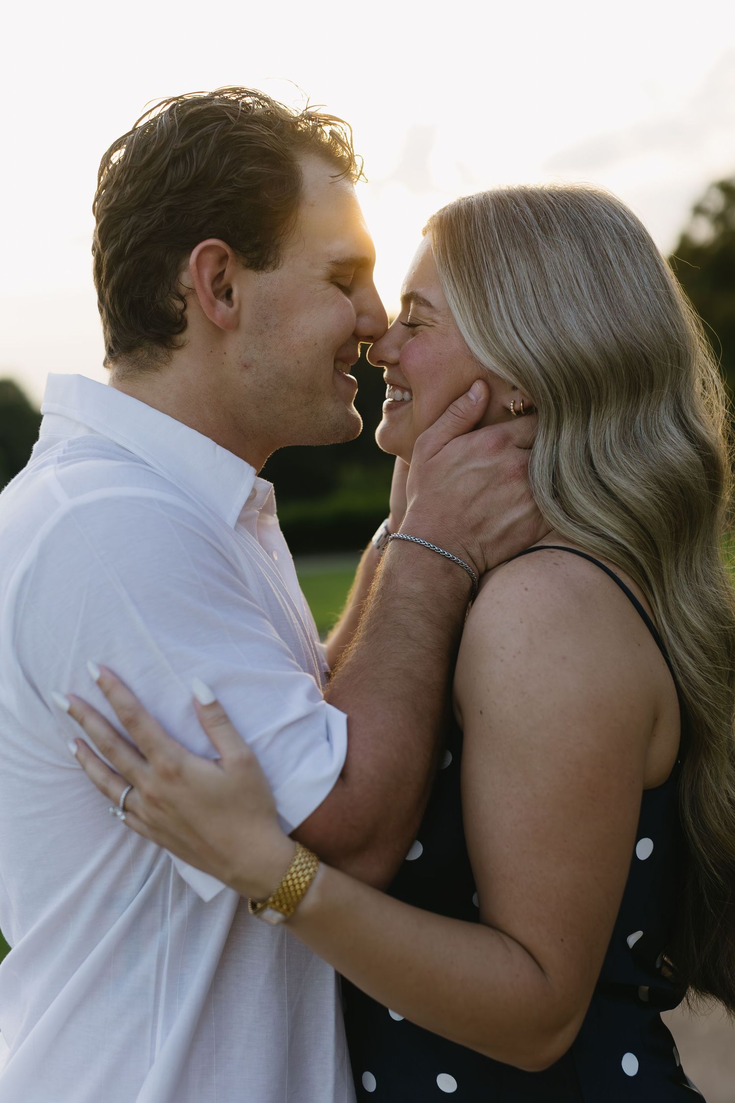 A romantic outdoor kiss sequence showing a couple in a white shirt and polka dot dress during golden hour.