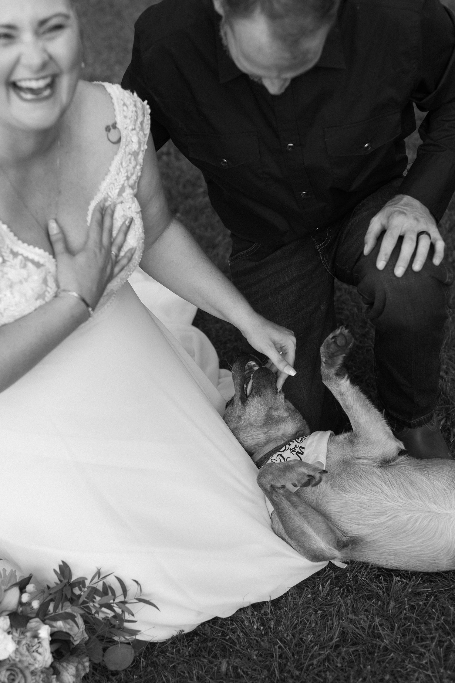Candid black and white wedding photos showing couple sitting on grass.