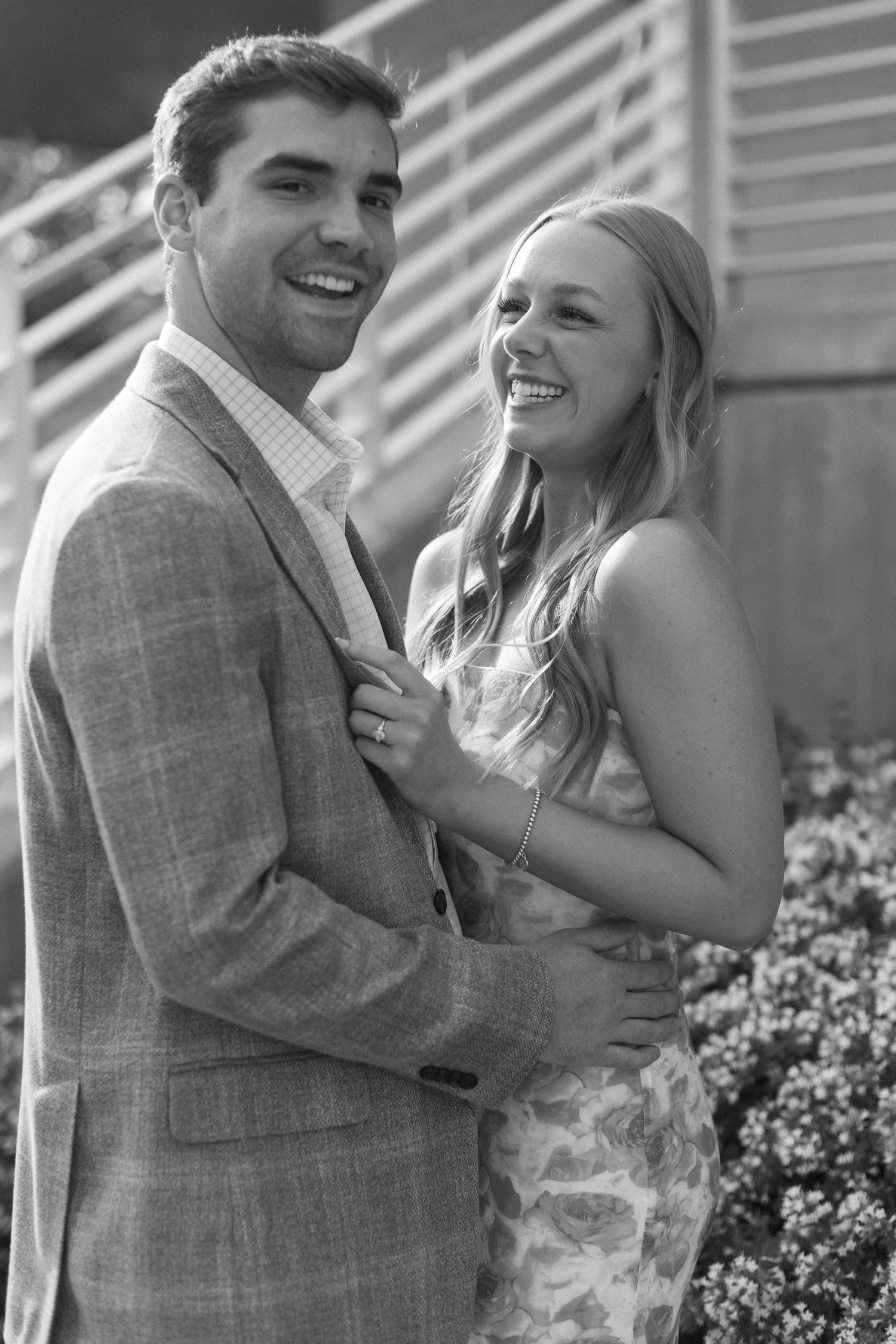 Happy couple sharing joyful moments together outdoors by architectural steps.