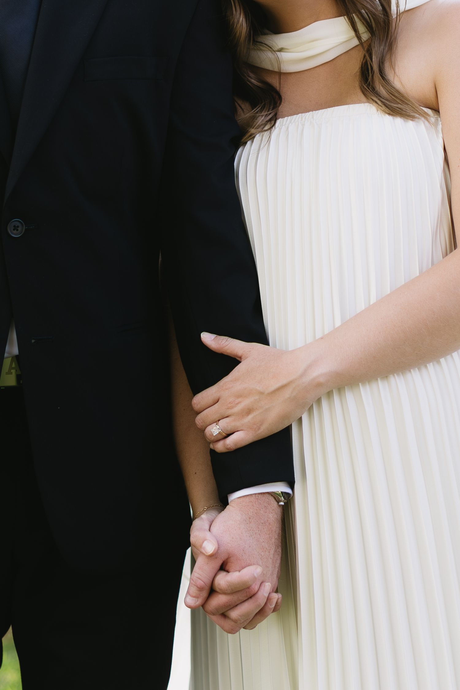 Close-up of couple holding hands during their wedding ceremony.