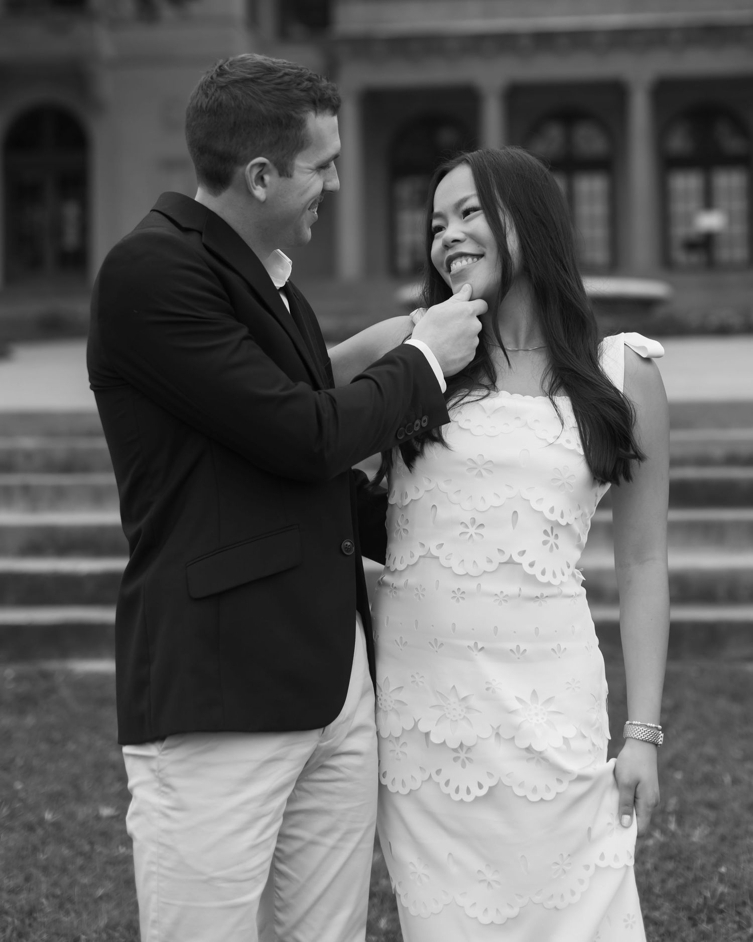 Black and white romantic portraits captured on the grounds of a classic building.