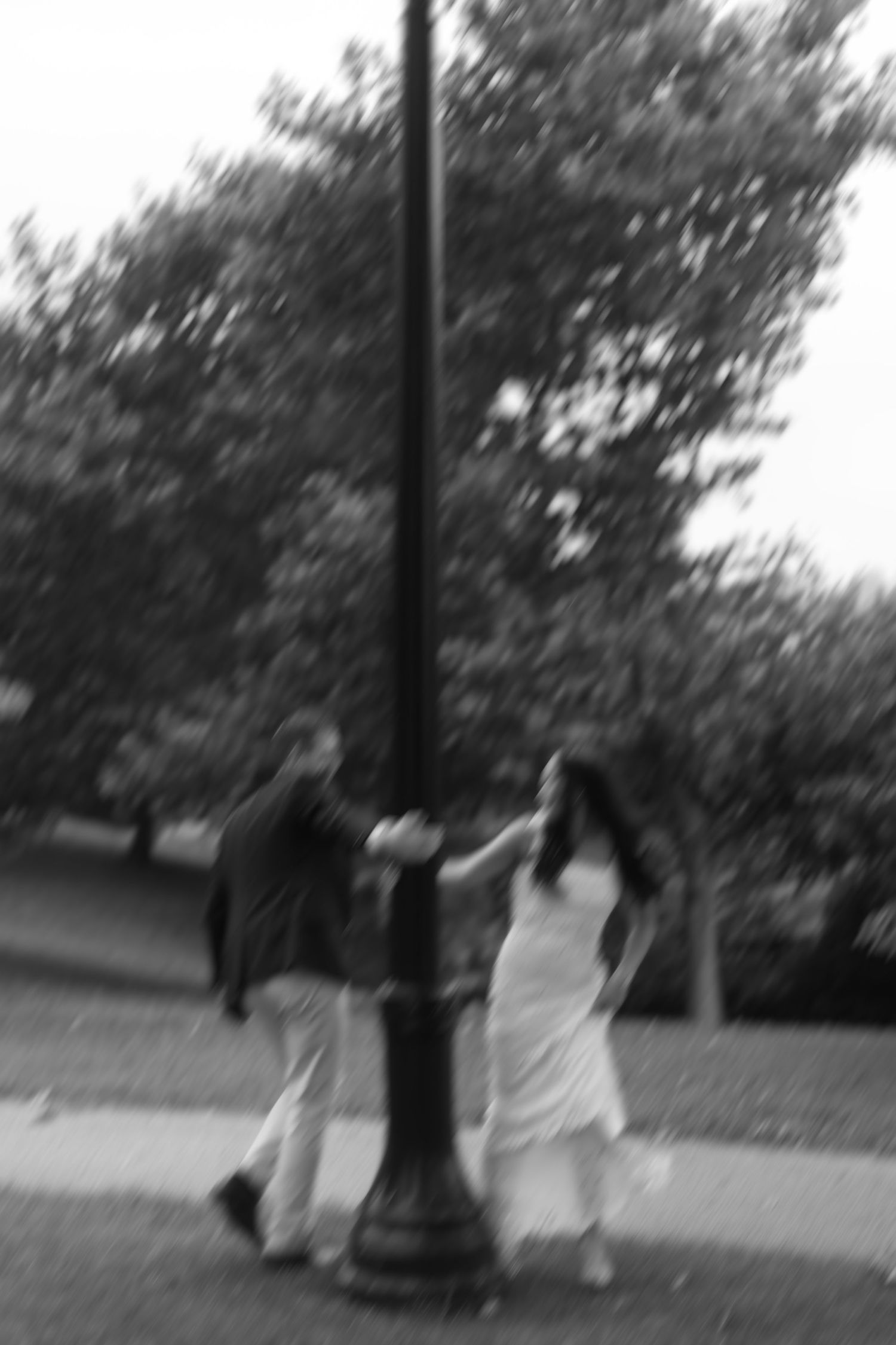 Artistic motion blur black and white photo of a couple walking outdoors.