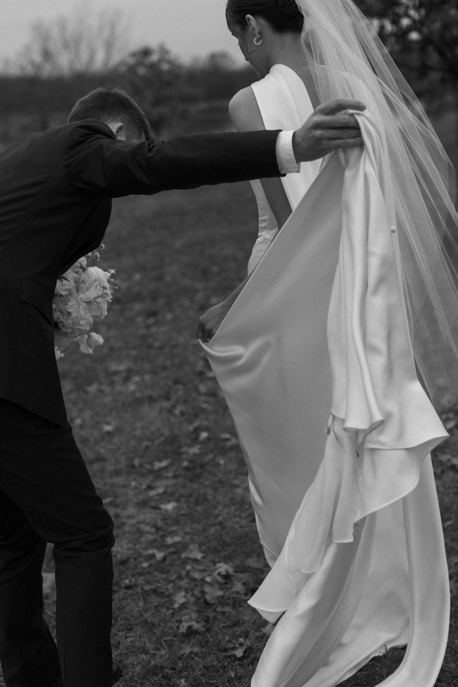 Black and white artistic wedding photos showing movement of bride's flowing dress and veil.