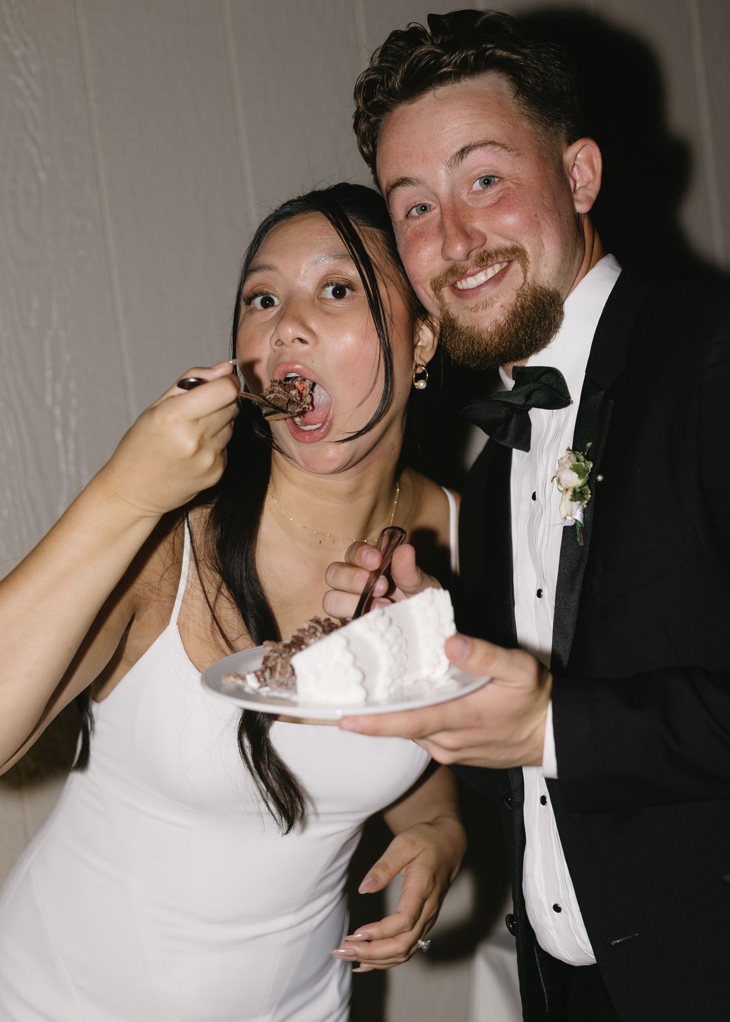 Playful wedding reception moments captured in candid black and white photography.
