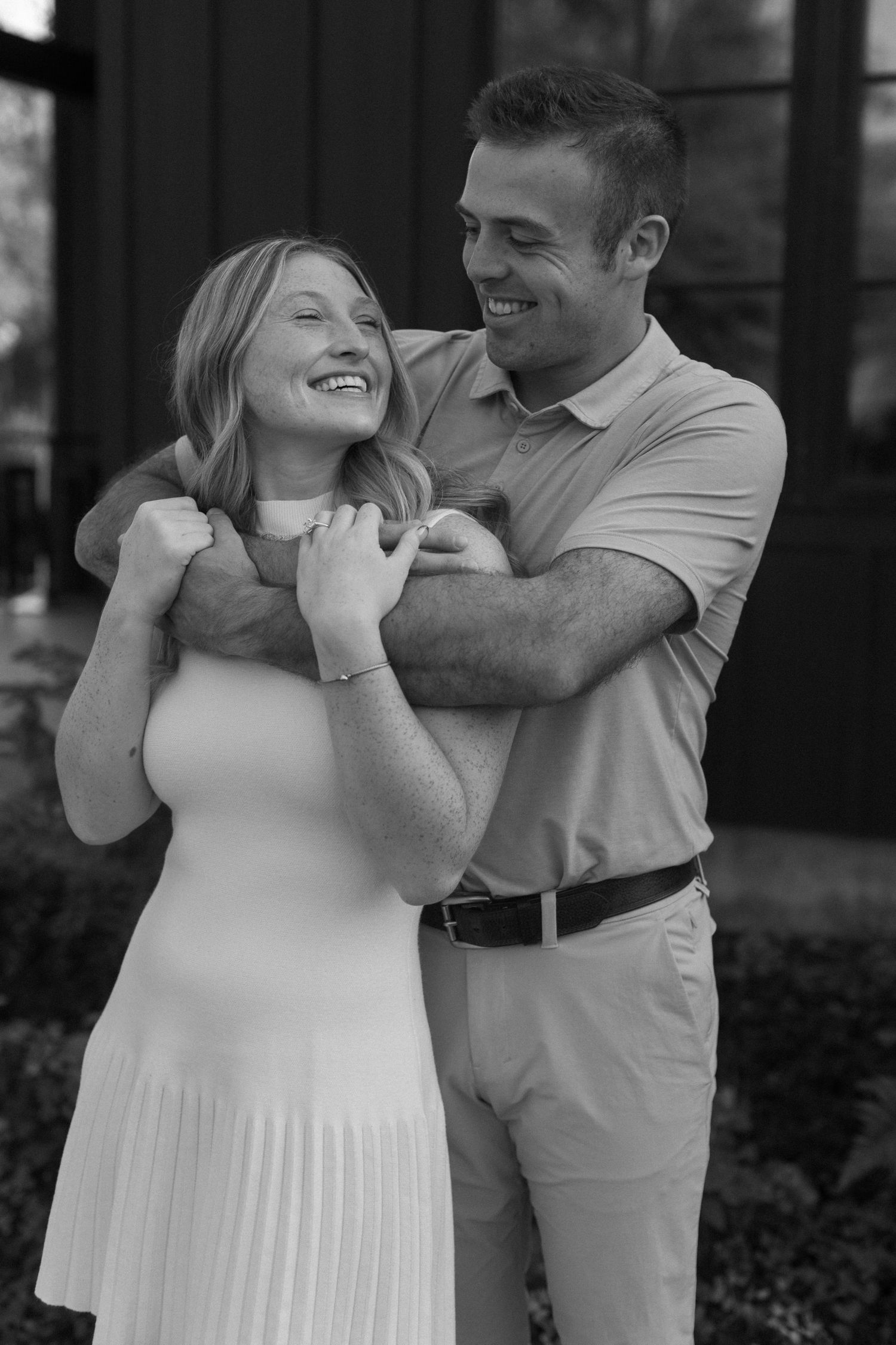 Black and white photos of couple embracing and laughing together outdoors.