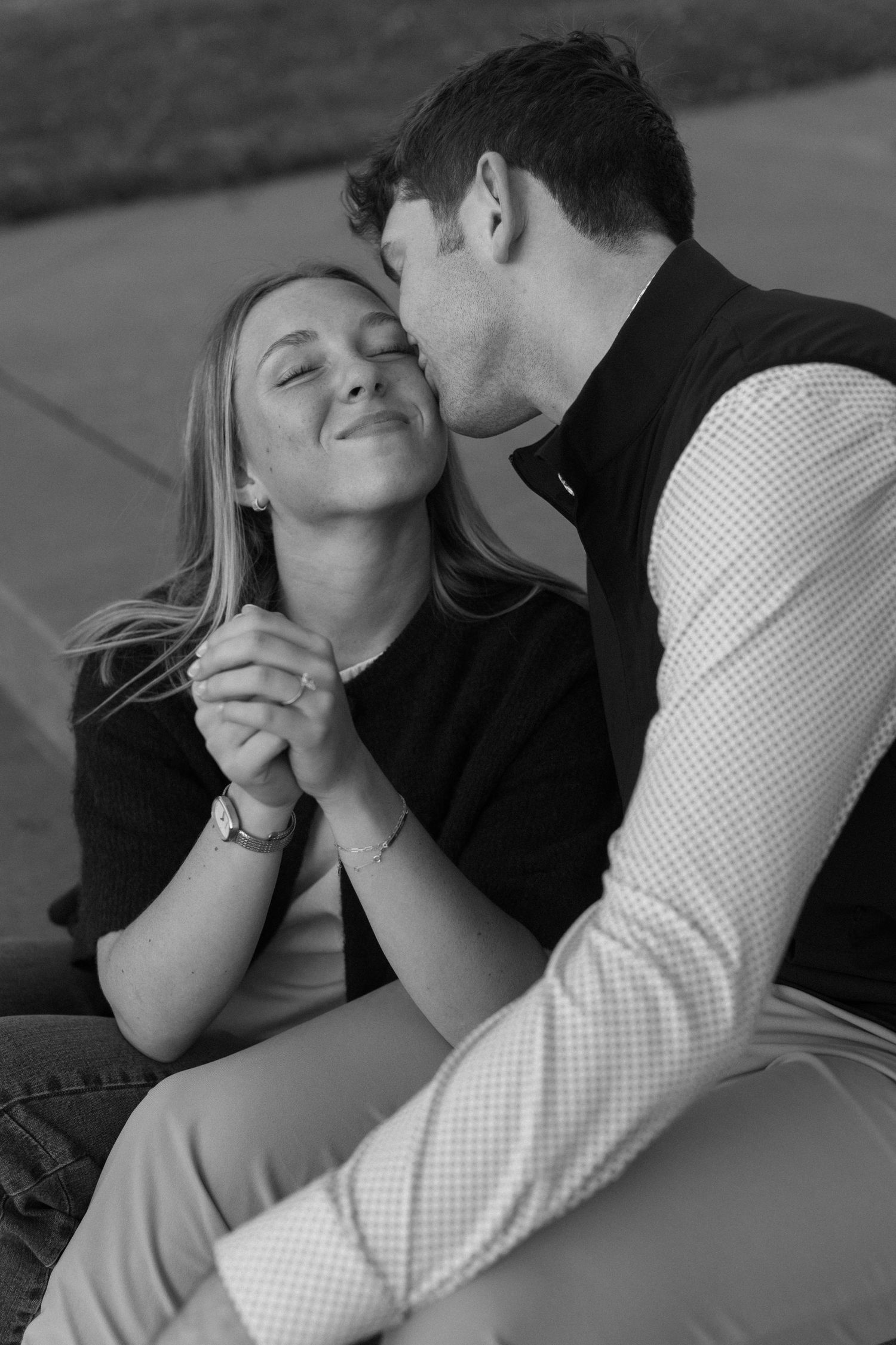 Black and white intimate photos of a couple sharing tender moments and laughter while lying down.