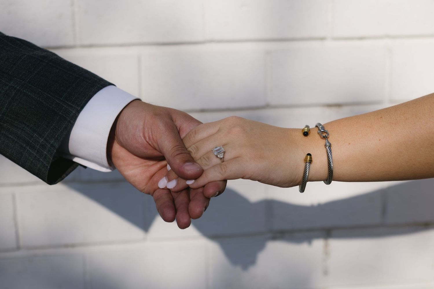 Close up shot of hands exchanging property keys on white background.