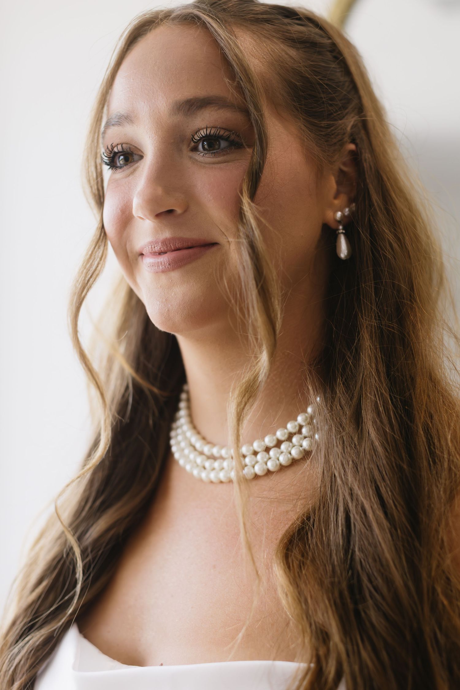 Close-up portrait shots showing elegant pearl choker necklace and bridal jewelry details.