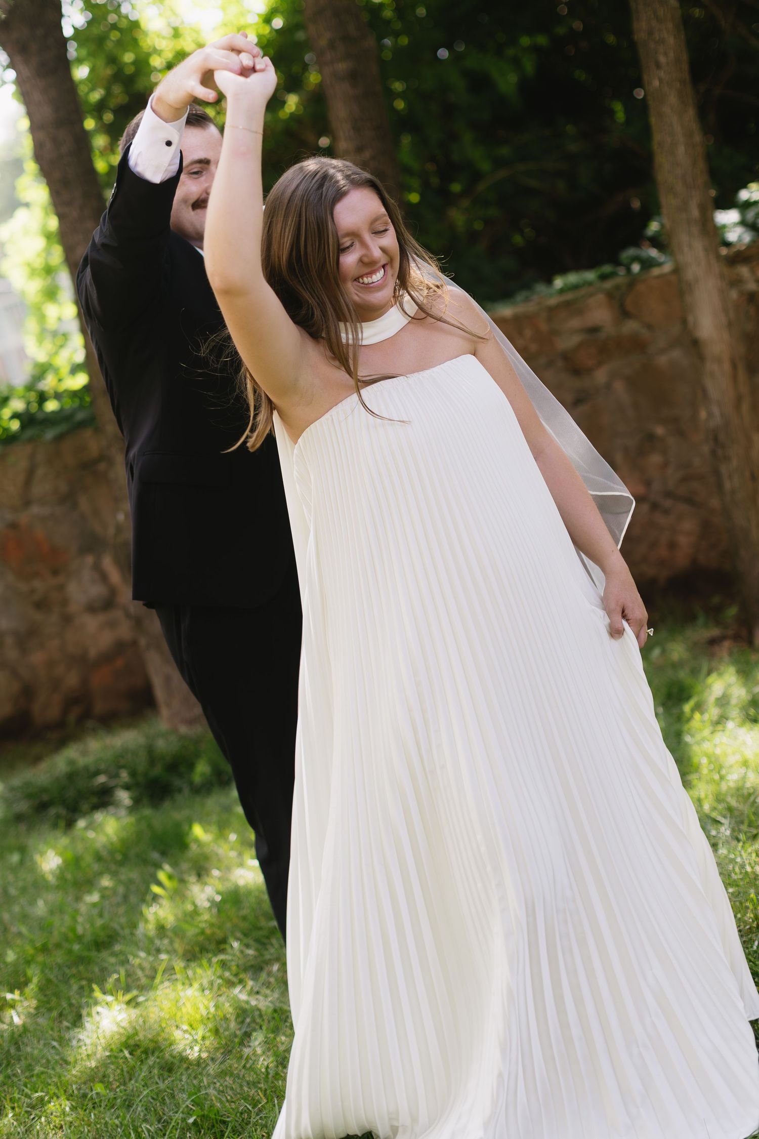 A series of celebratory dance moves in a white dress against a lush green garden background.