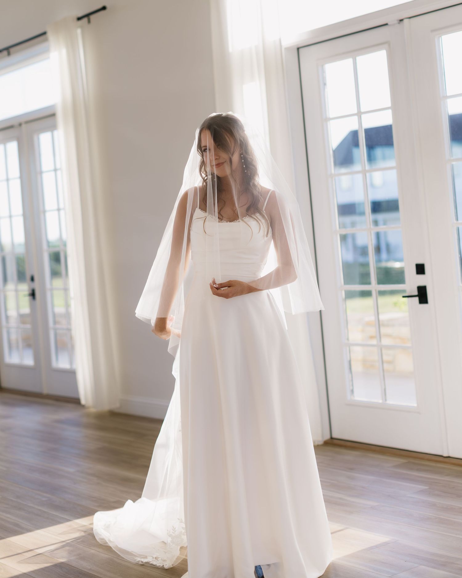 Series of minimalist bridal portraits showing white dress and veil against bright windows in a modern space.
