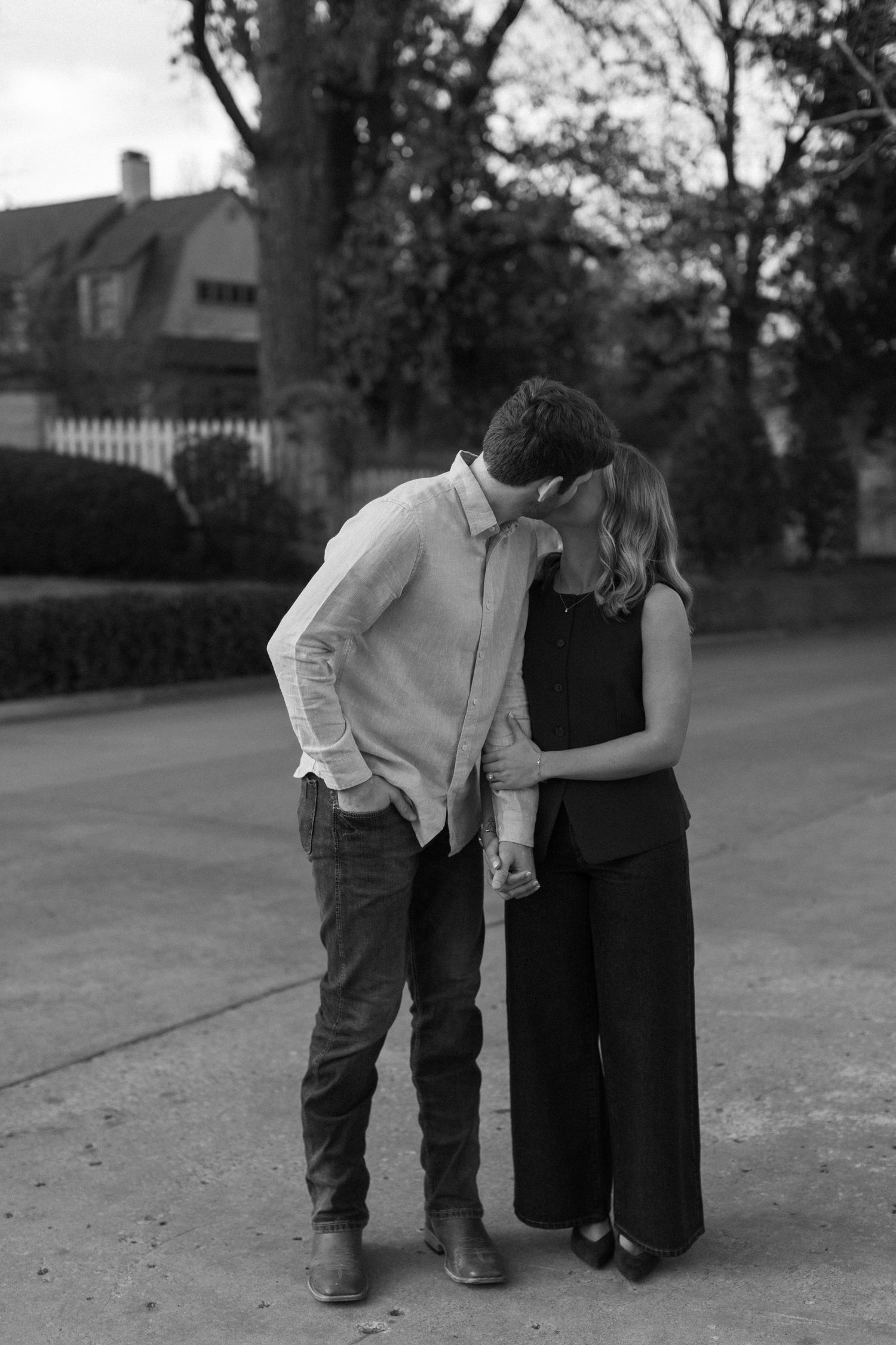 Black and white photo of a couple walking together outdoors.