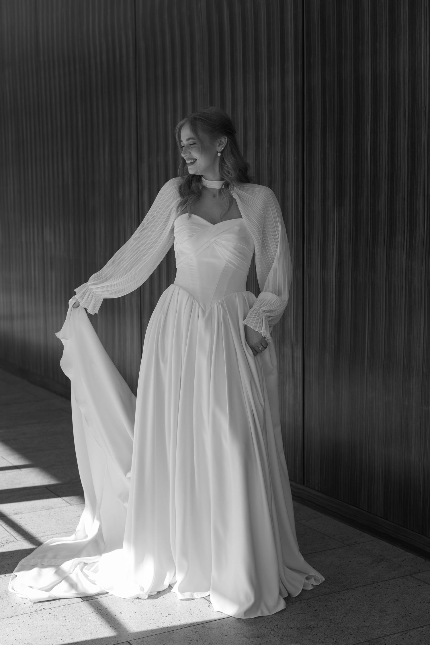Ethereal white dress flowing in dramatic black and white composition with natural lighting and shadows.