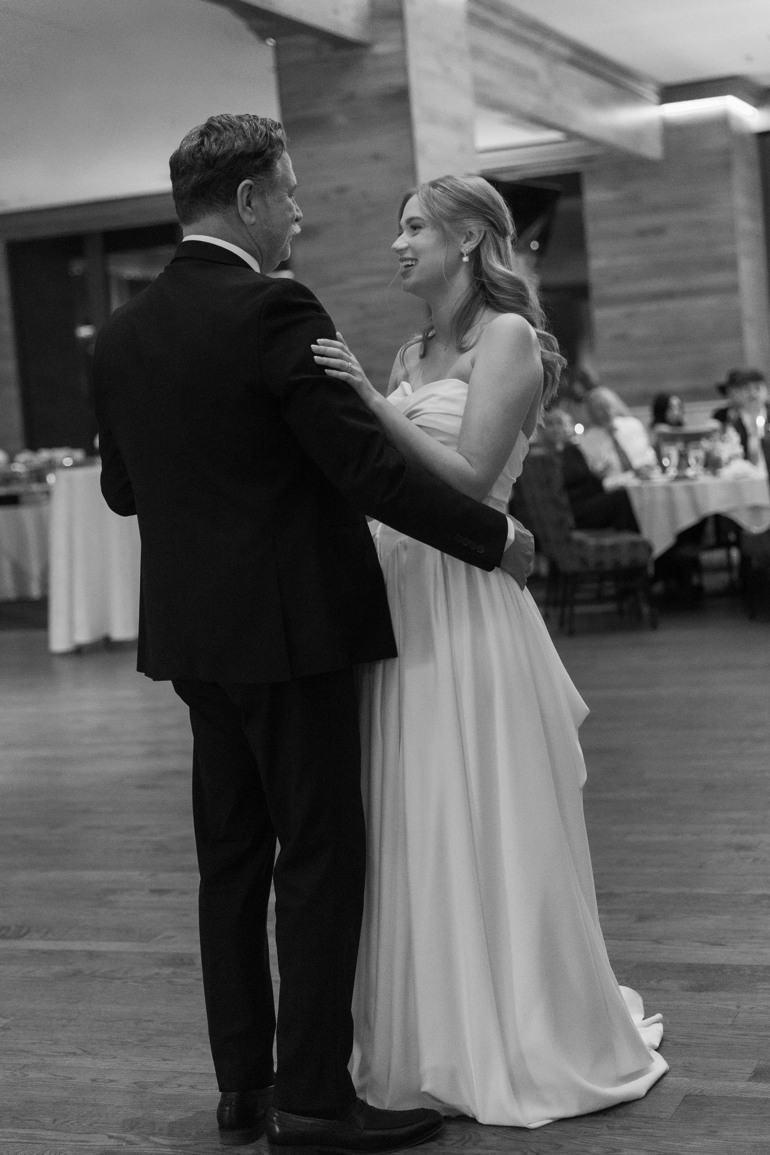 Wedding couple sharing an intimate dance moment in black and white.