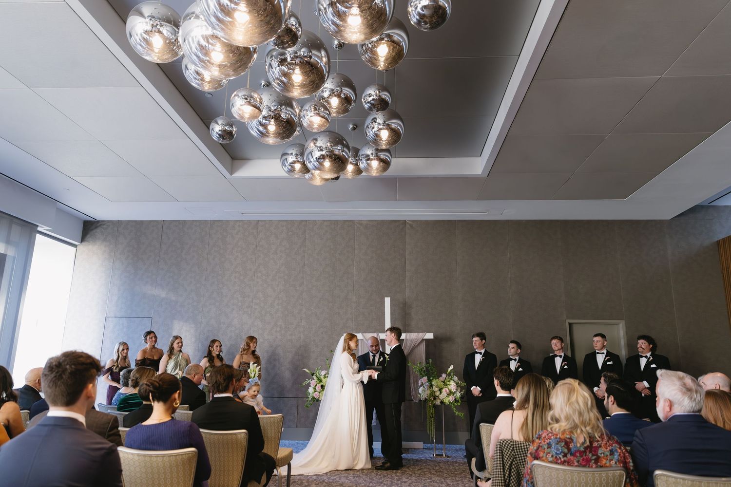 Interior view of a wedding reception venue with modern ceiling lights.