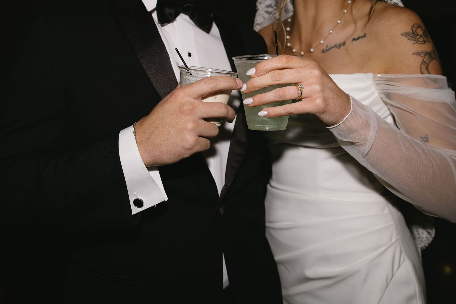 Wedding reception detail shot of formal attire and drinks being held.