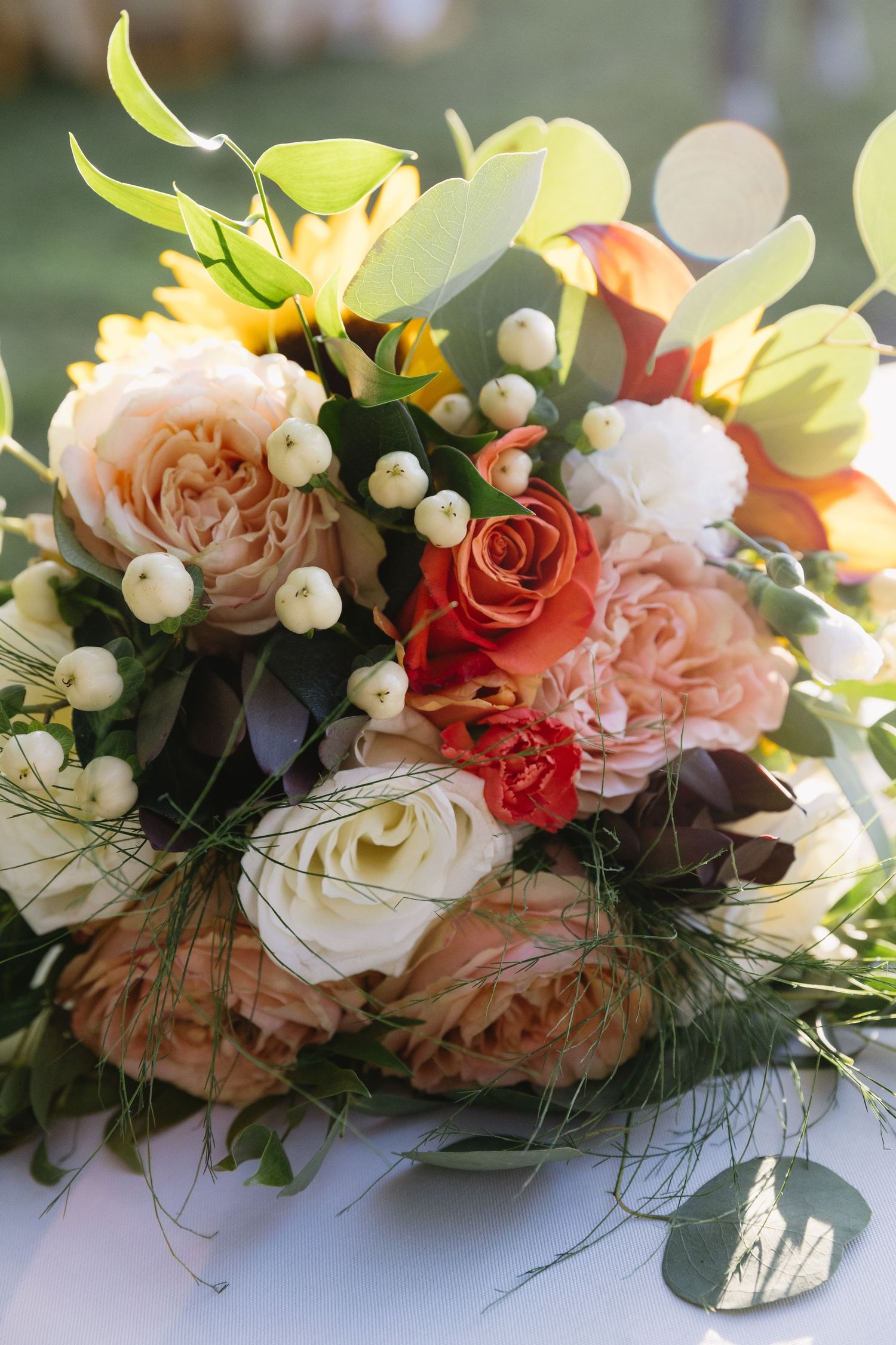 Close-up of romantic floral arrangement with pink and coral roses mixed with white blooms.