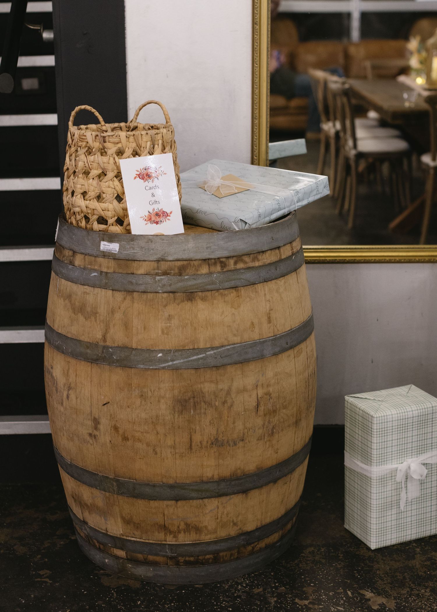 Wooden wine barrels displayed with white gift boxes on top.