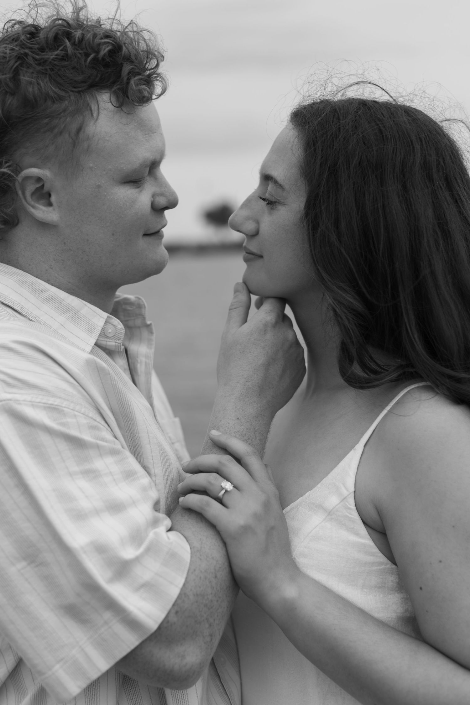 Intimate black and white portraits capturing tender moments between lovers.