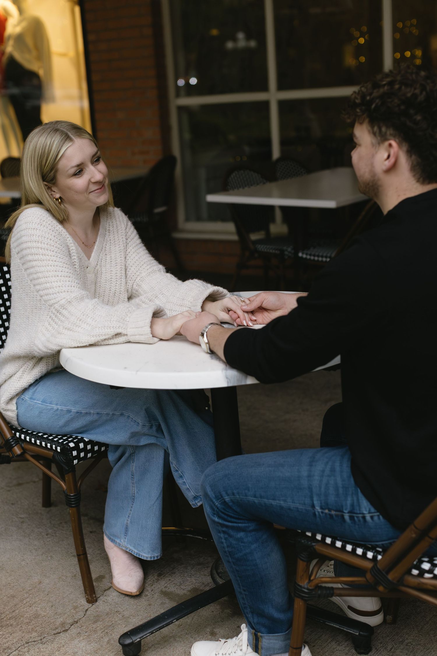 A couple sharing intimate moments while relaxing on outdoor furniture.