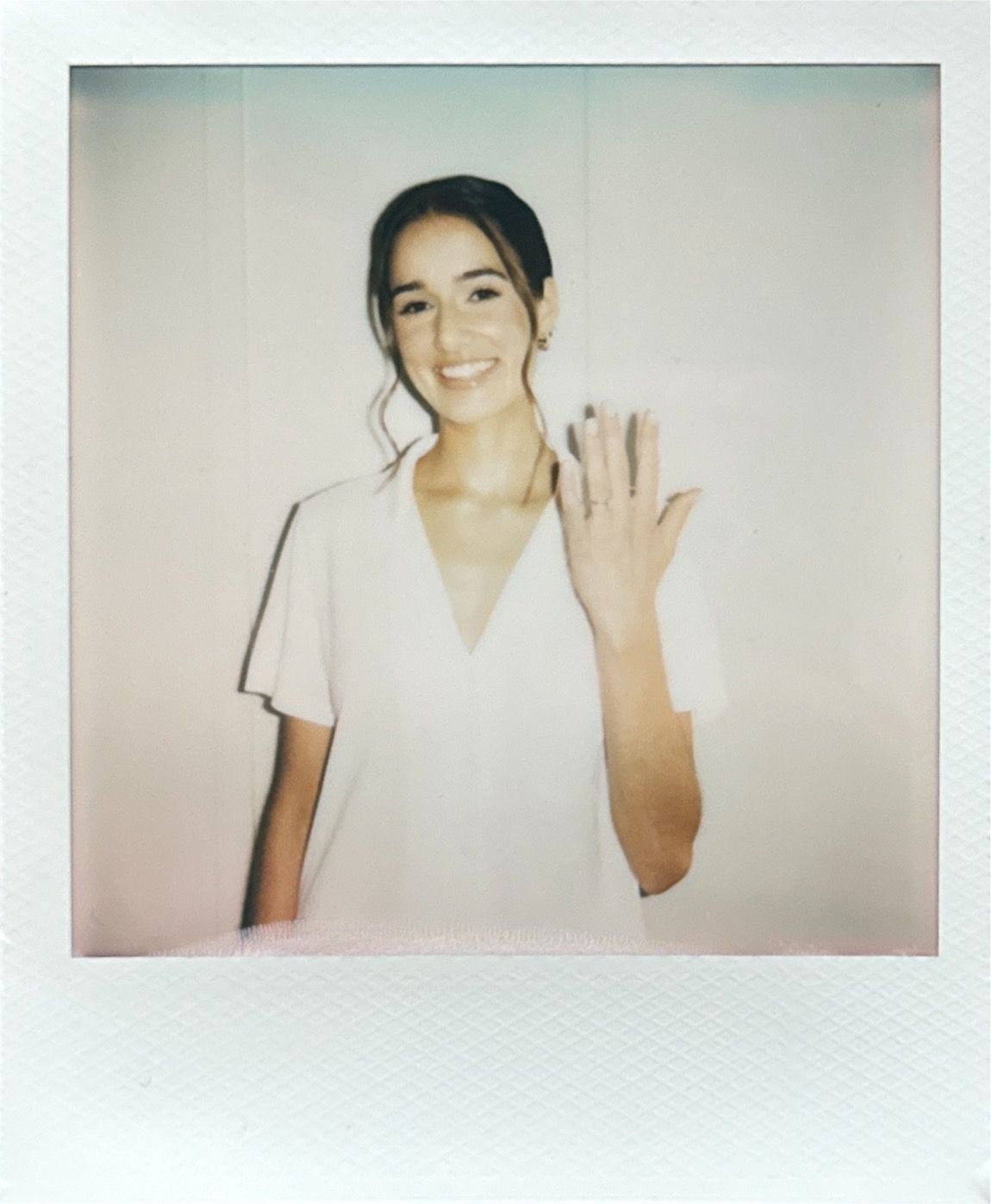 Series of polaroid photos showing someone in white clothing against a light background.