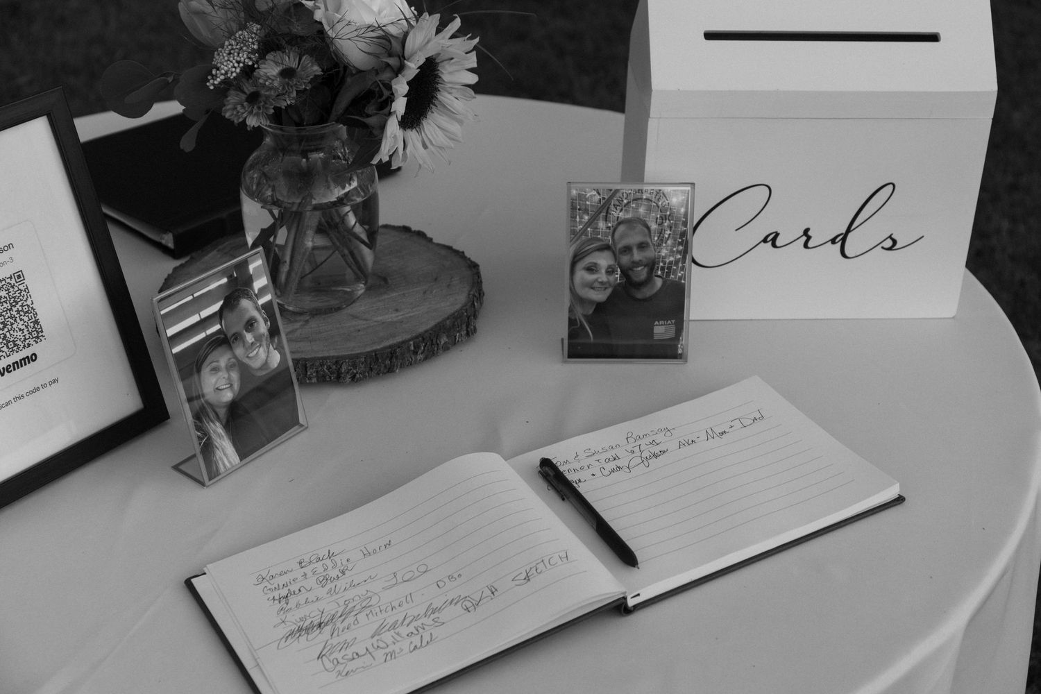 Wedding guest book table setup with pens and cards for writing messages.