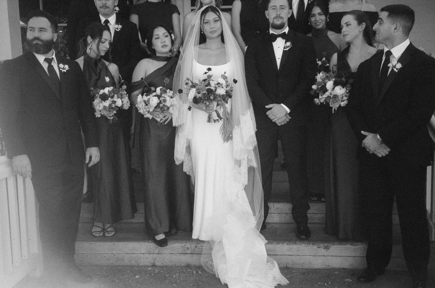Black and white photo of wedding guests gathered for a formal ceremony.