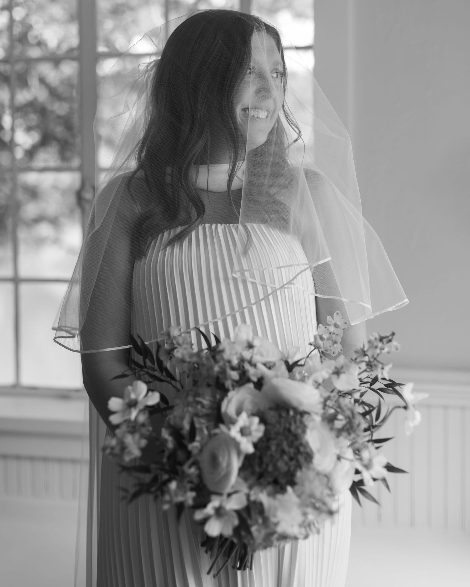 Black and white photograph of wedding bouquets featuring delicate flowers and greenery.