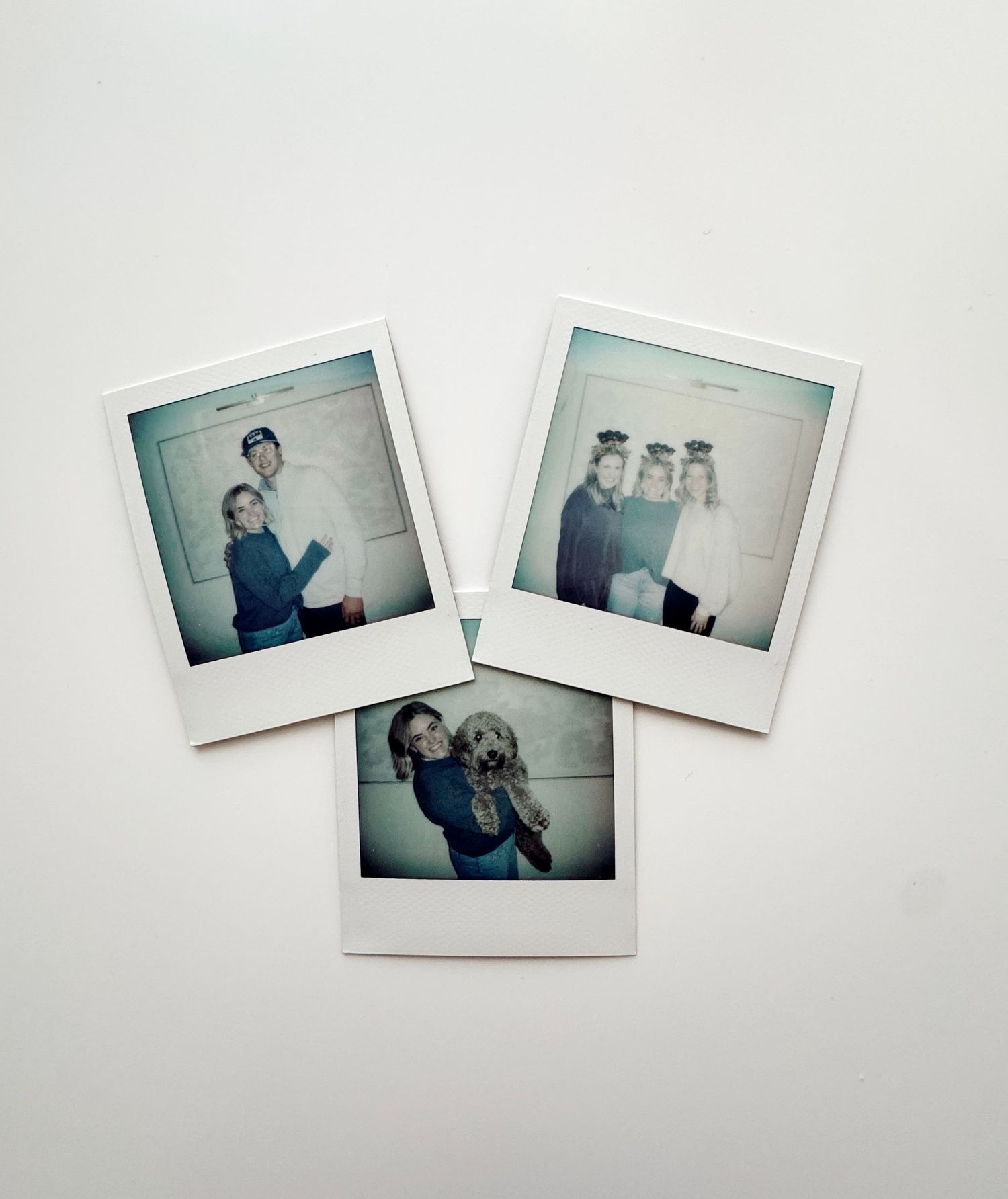 Multiple vintage-style polaroid photographs arranged artistically against a plain white background.