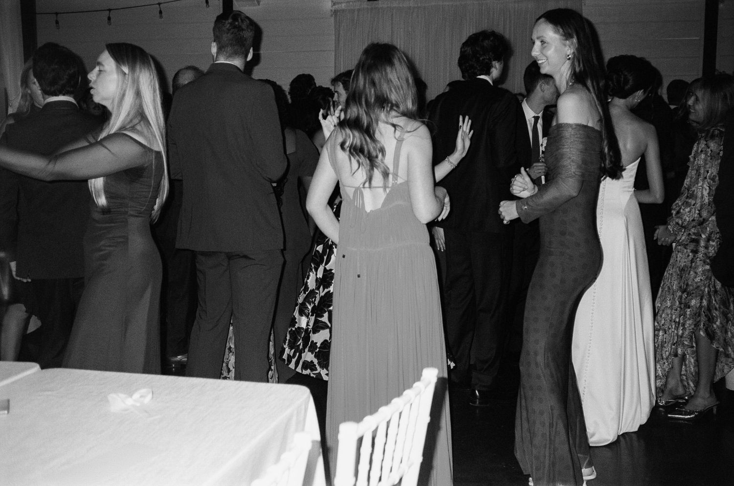 Black and white candid shots of wedding reception dance floor moments.