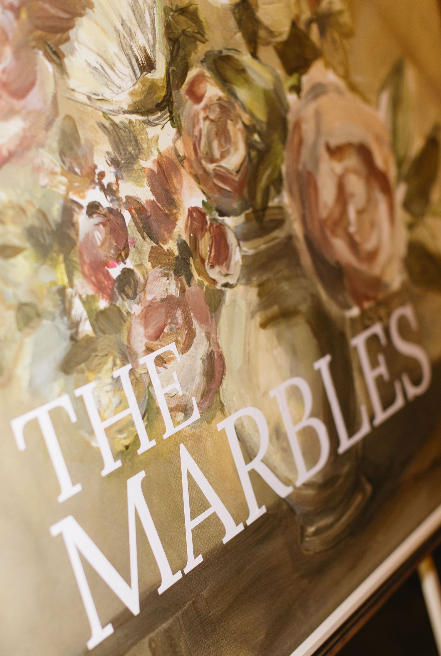 Close-up of decorative wedding signage with floral details.