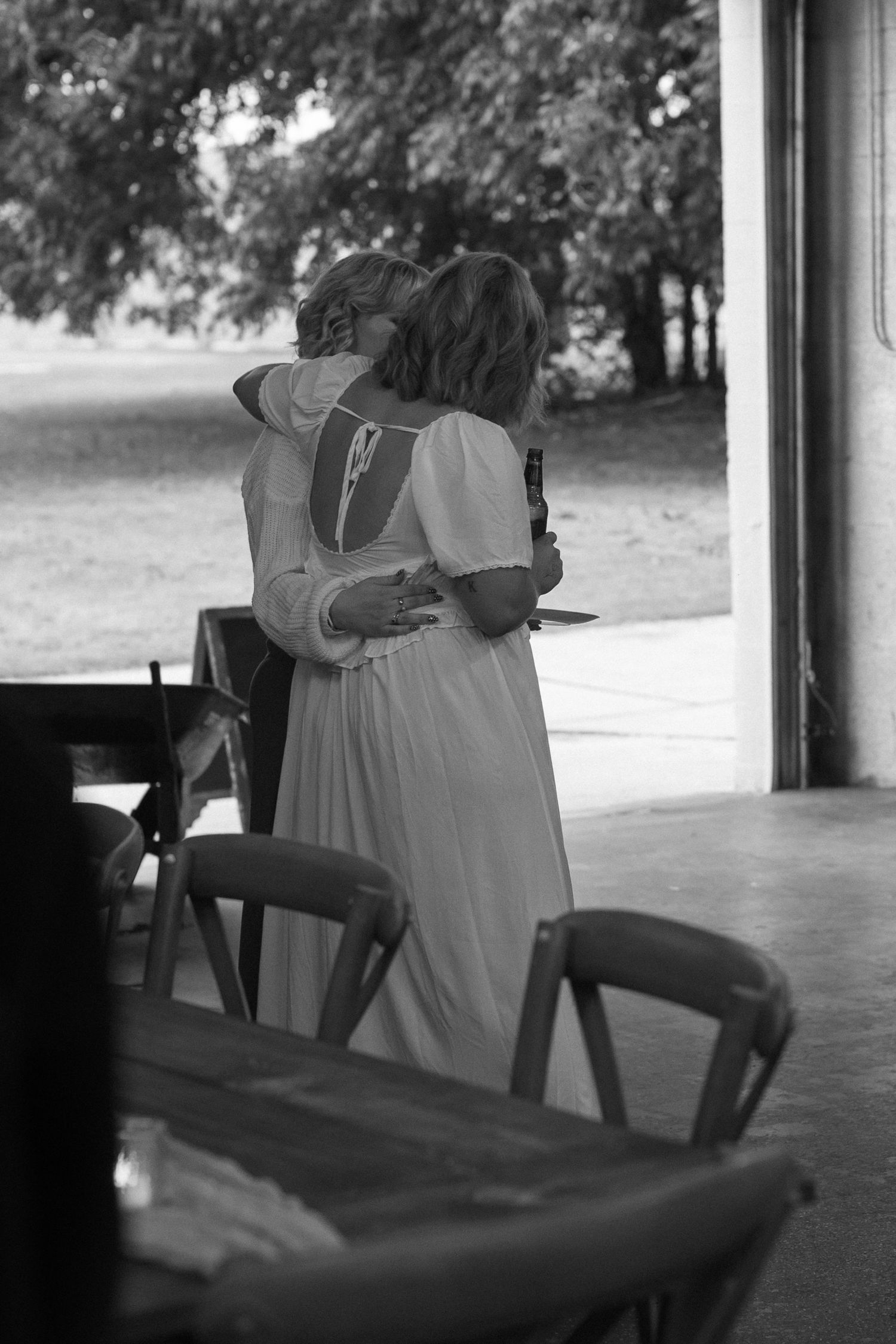 Empty chairs lined up at an outdoor covered venue space.