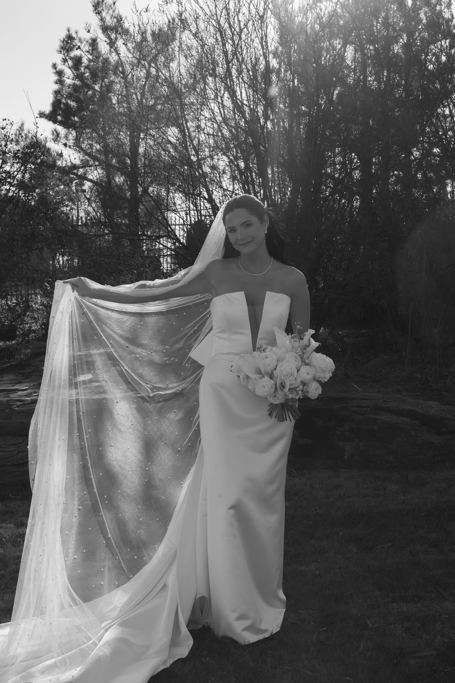 Flowing white wedding veil billowing in the outdoor breeze.