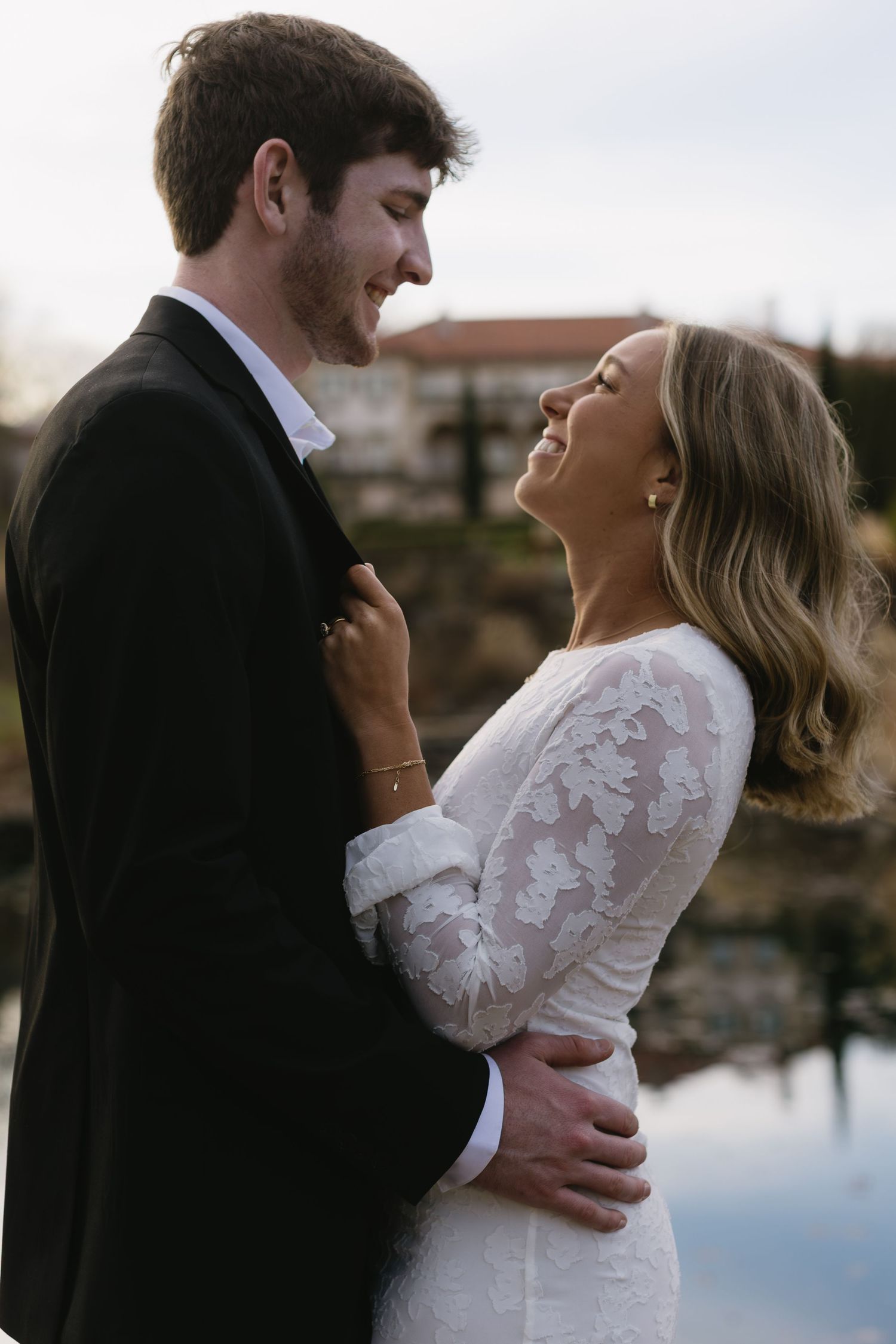 A joyful couple embraces outdoors during a photo session.