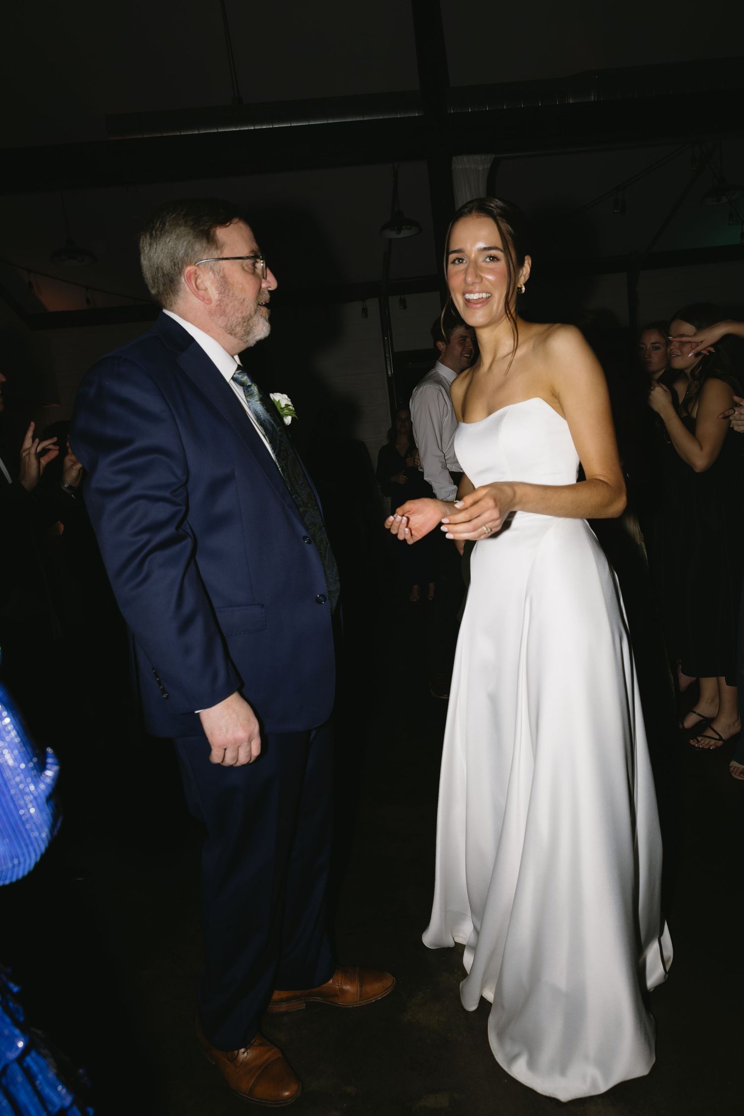 A candid moment during the wedding reception on the dance floor.
