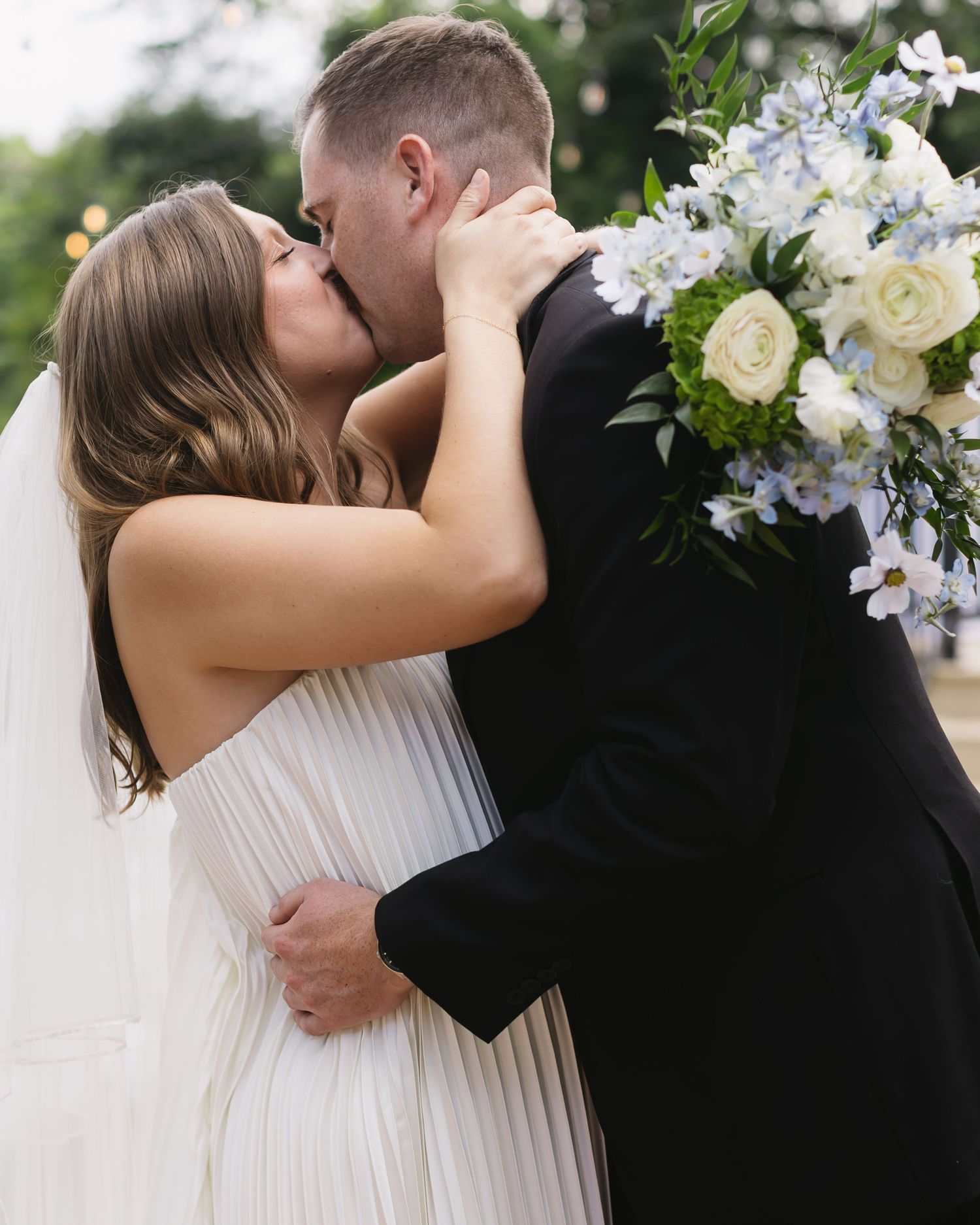 Romantic embraces captured in a series of intimate wedding moments with white and blue floral bouquet details.