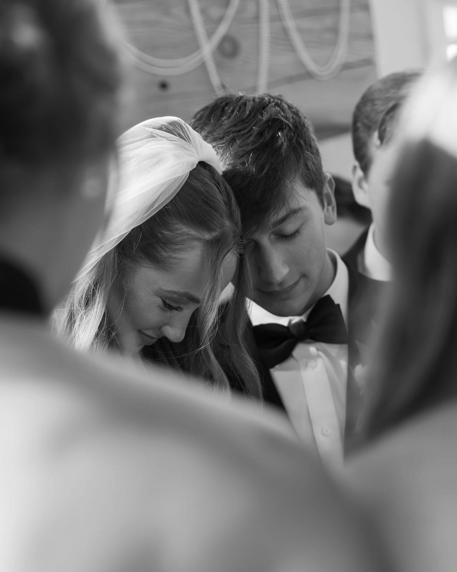 Intimate black and white wedding moment captured during celebration.