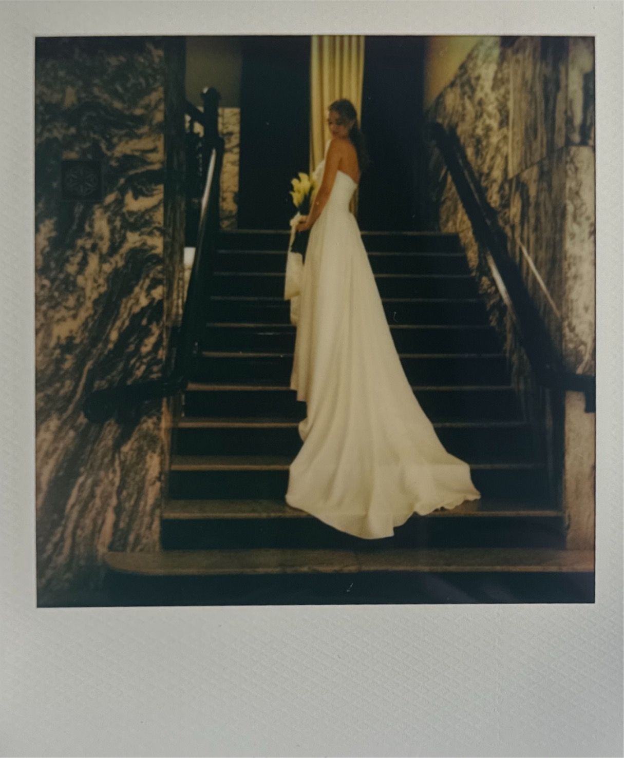 Artistic sequence of a flowing white dress descending grand stairs.