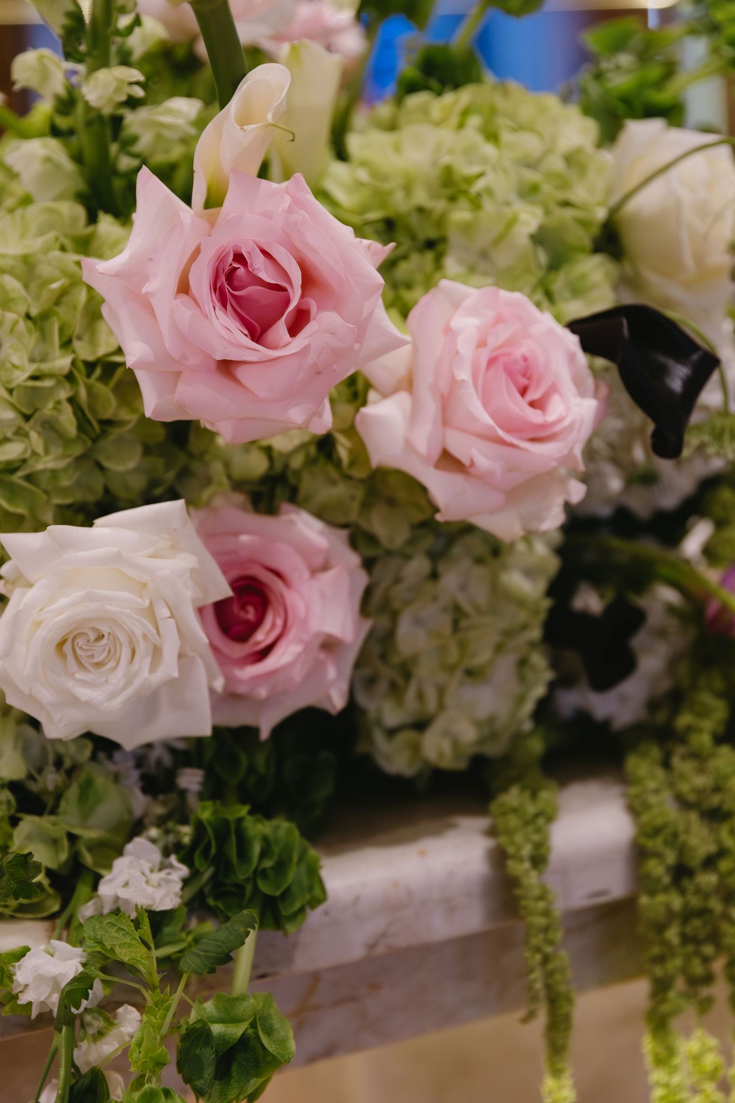 Elegant floral centerpiece with pink roses and white hydrangeas.