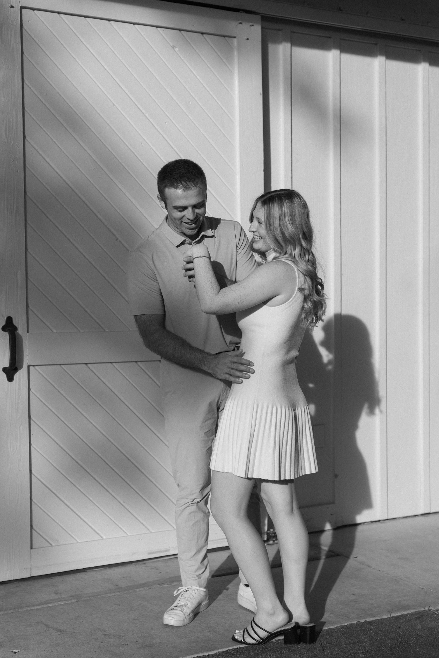 Series of intimate couple poses against a white wooden wall with dramatic shadows.