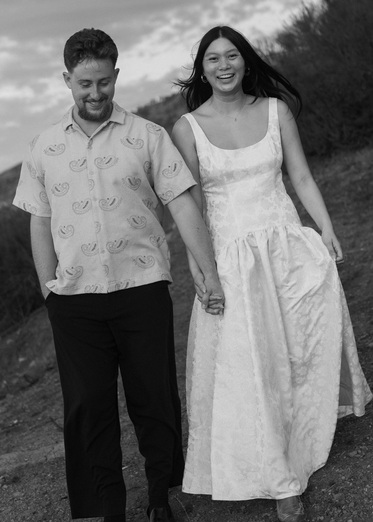 A couple walking together outdoors, shown in black and white from multiple angles.