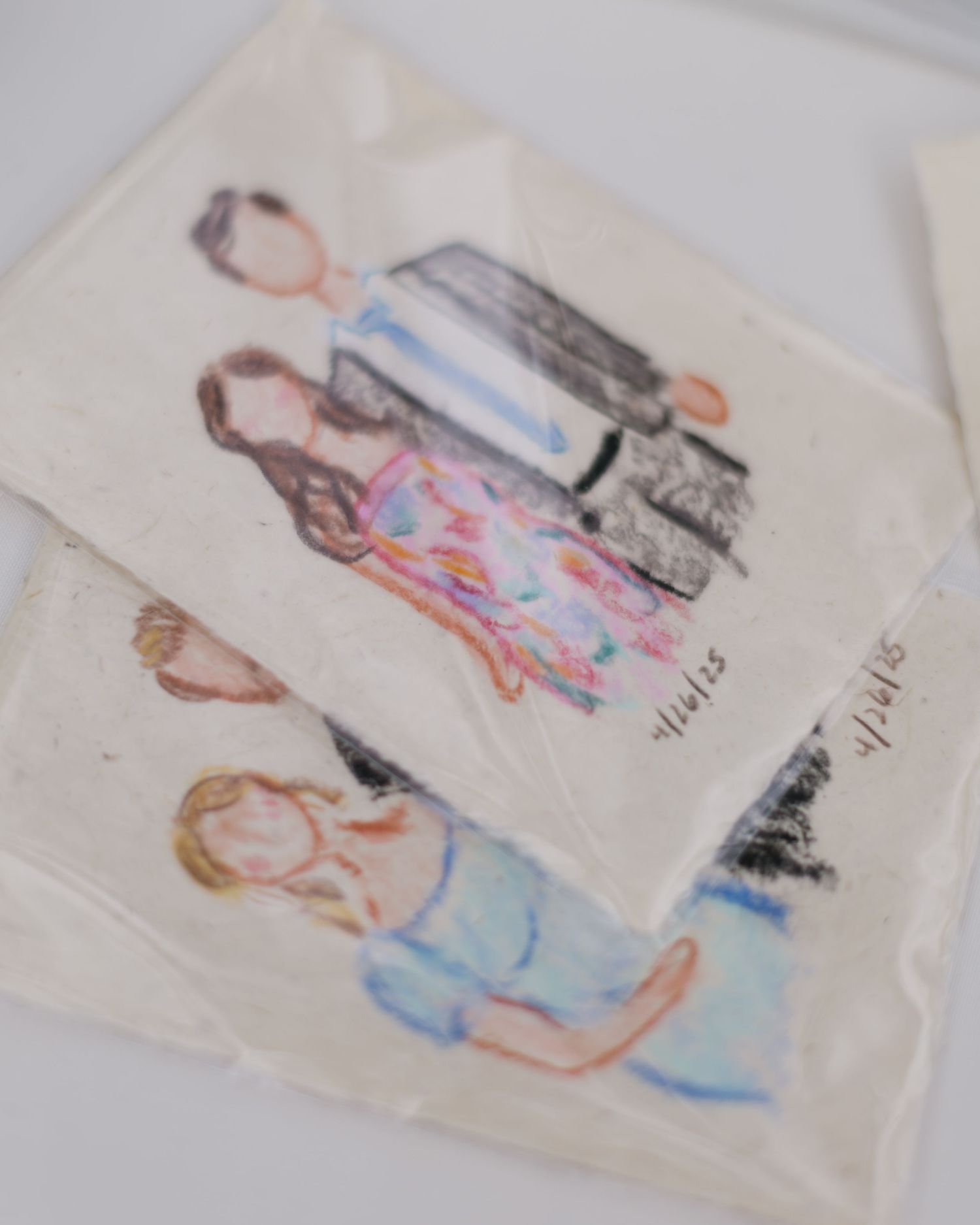 Delicate watercolor illustration showing a couple in wedding attire on white paper.