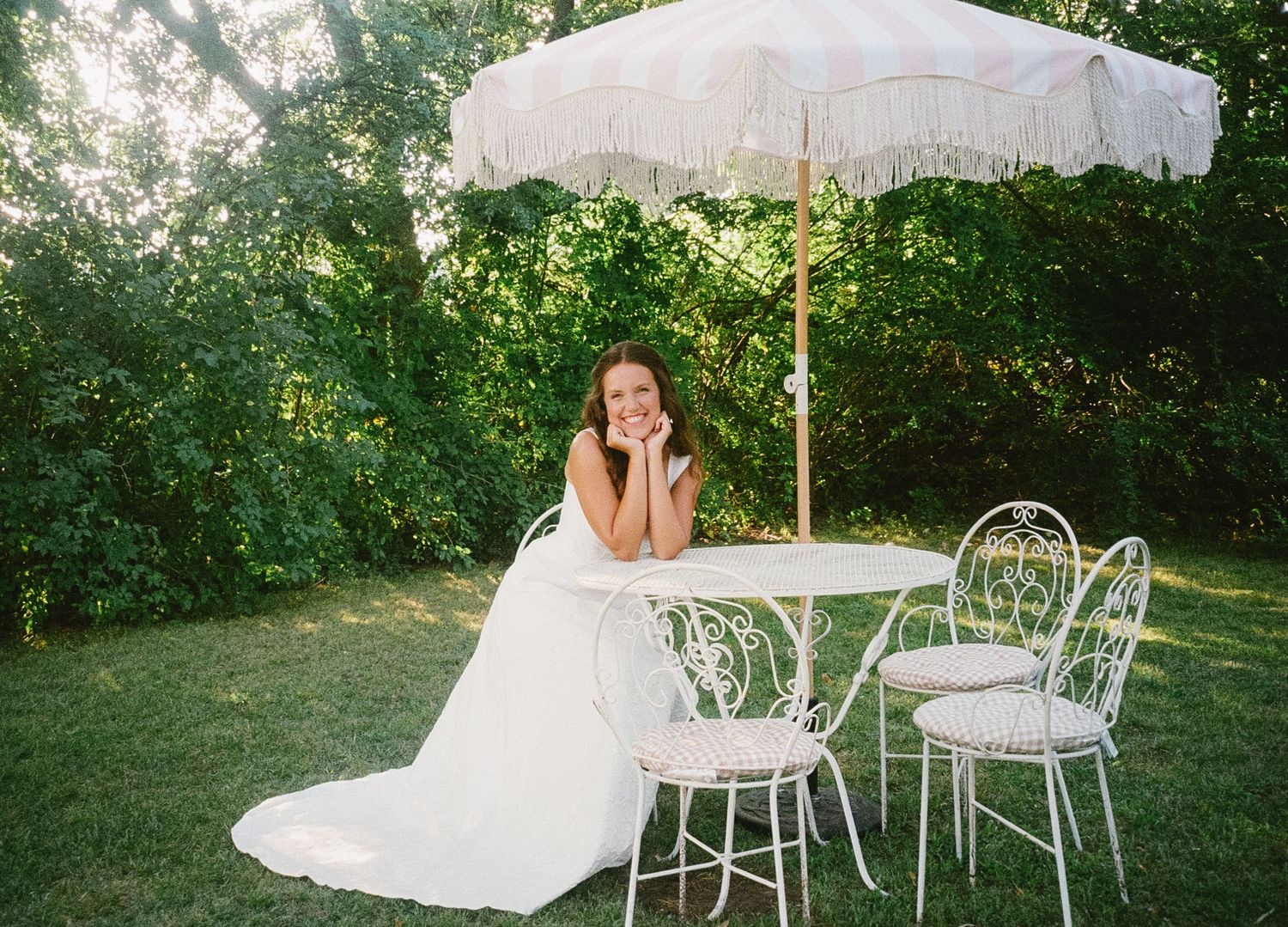 A row of romantic garden scenes with white furniture, parasols and delicate lace details in a sunlit outdoor setting.