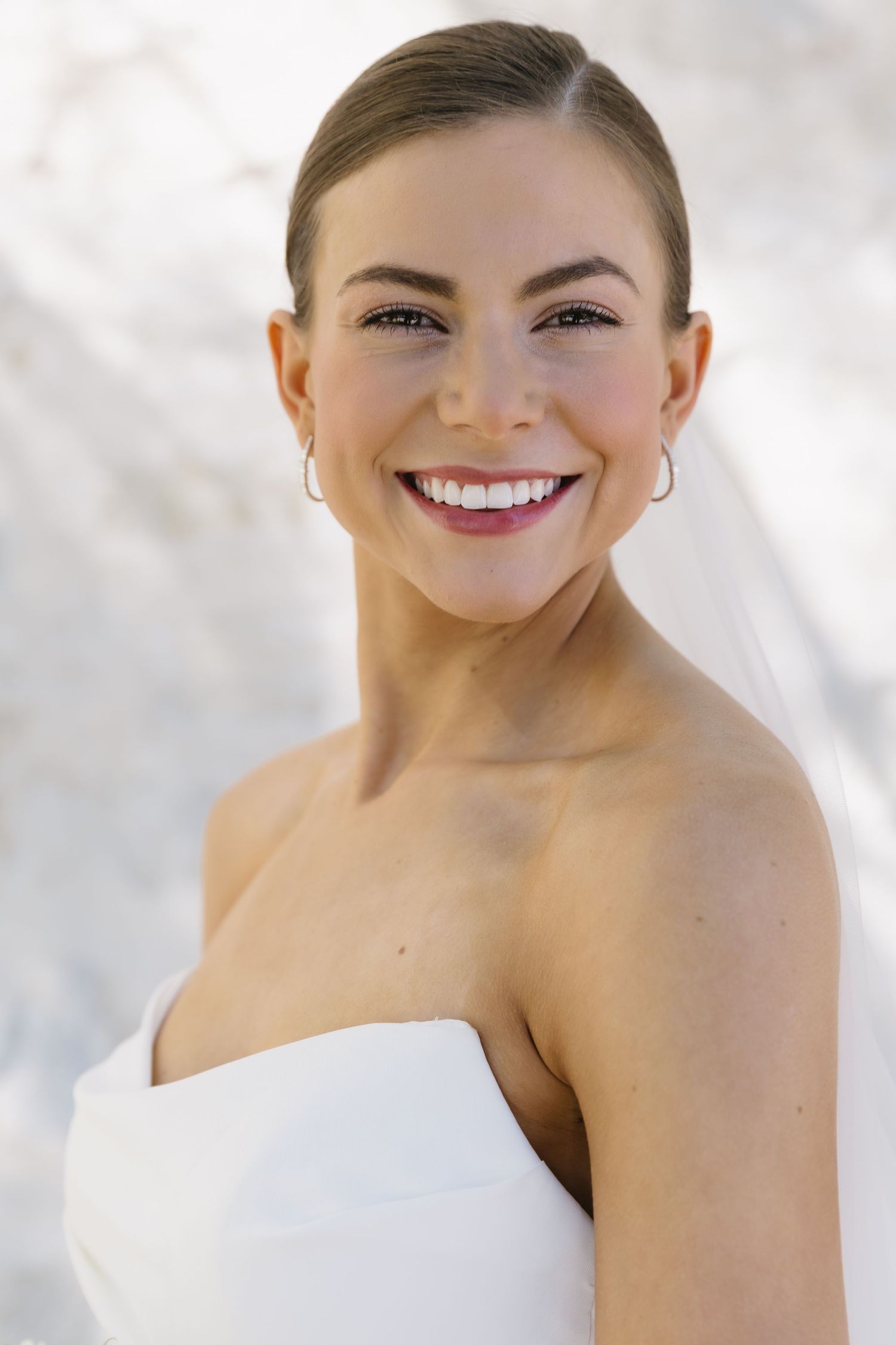 Close-up shot showing details of a classic white wedding dress.