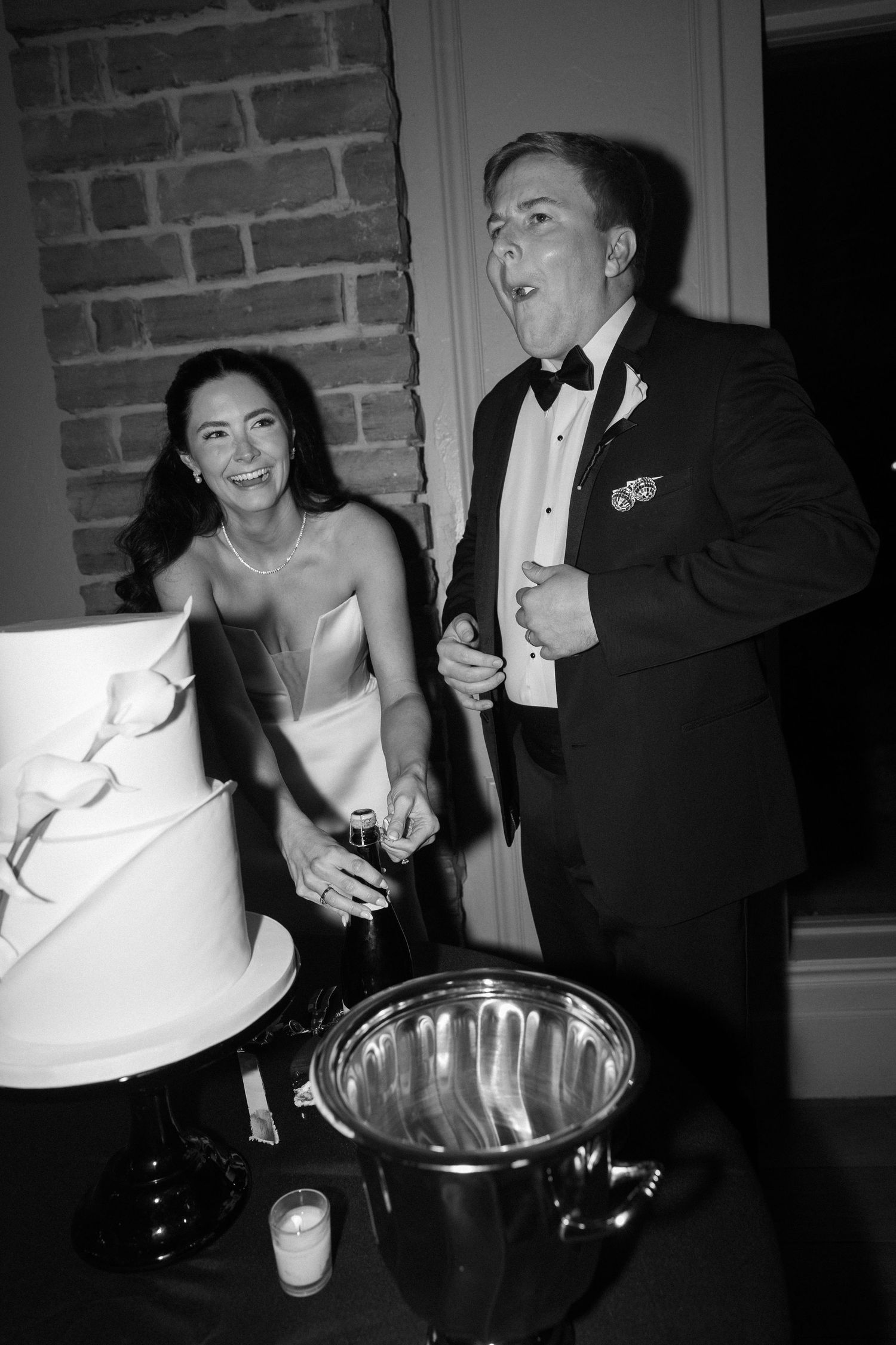 Wedding reception party scene with guests celebrating in black and white formal attire.