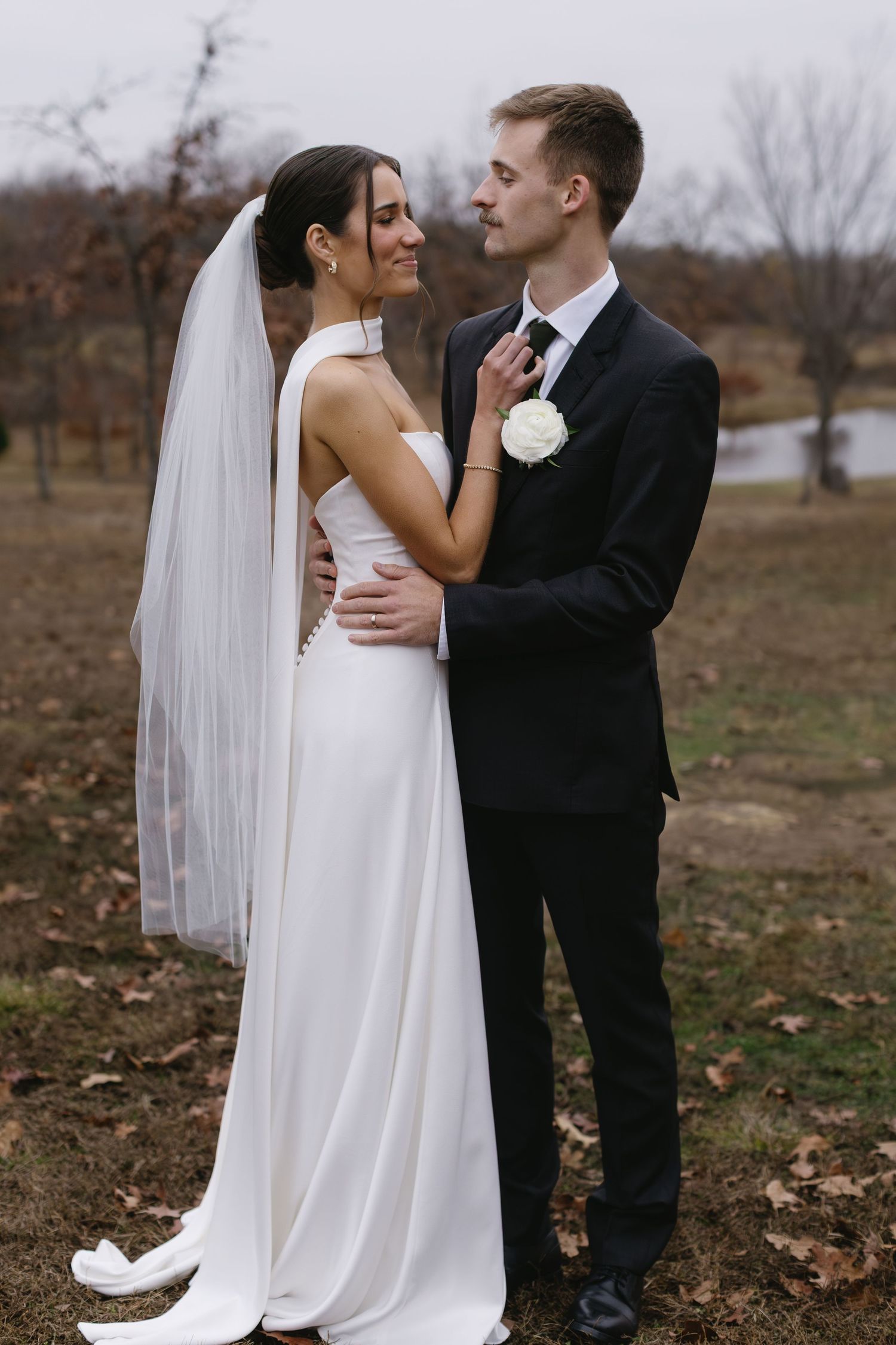 A tender moment between newlyweds during their outdoor wedding photoshoot.