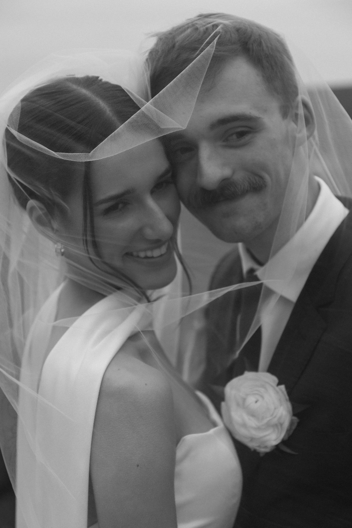 Romantic black and white wedding portraits showing tender moments between newlyweds.
