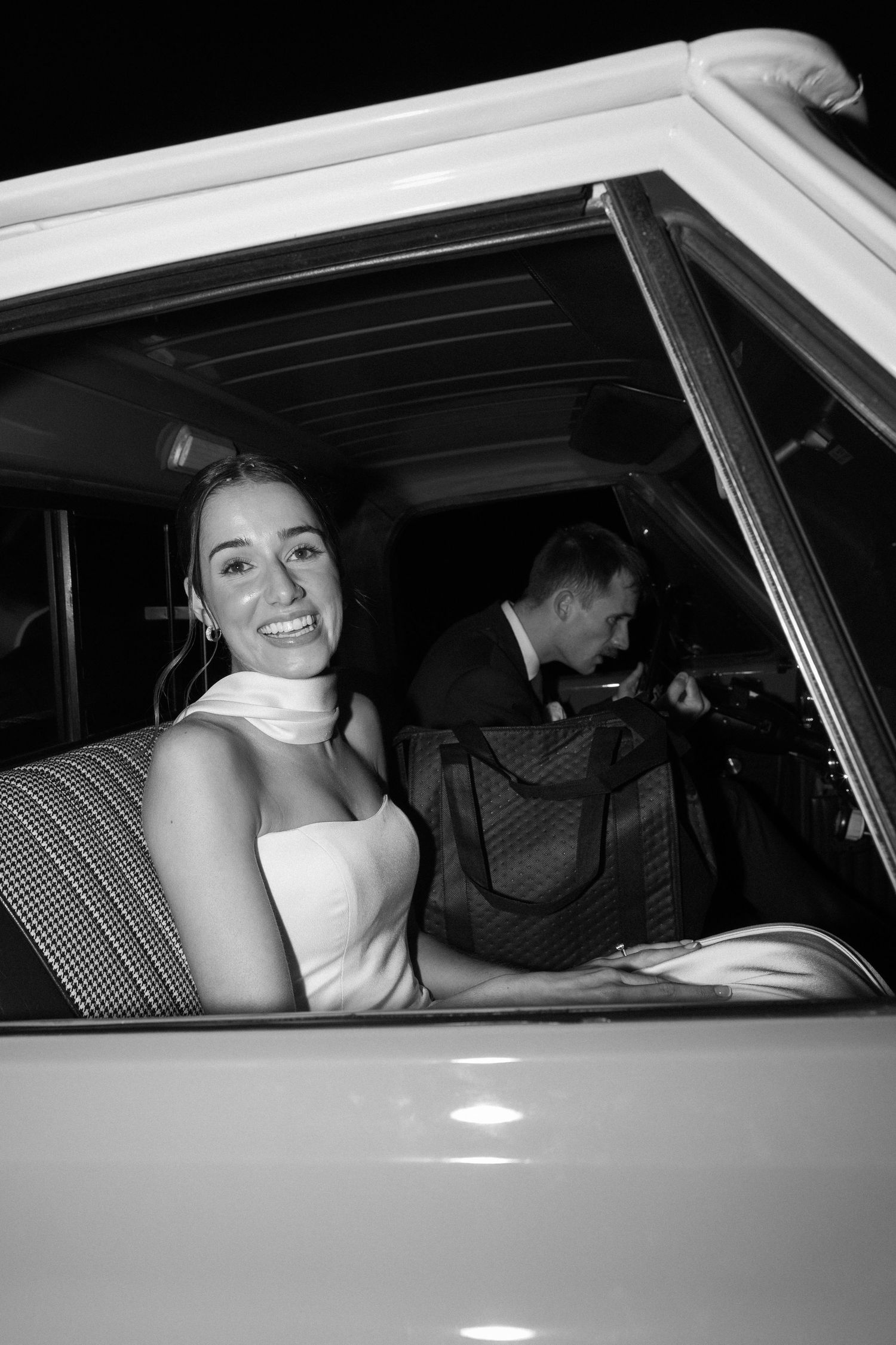 A classic getaway car moment captured in black and white photography.