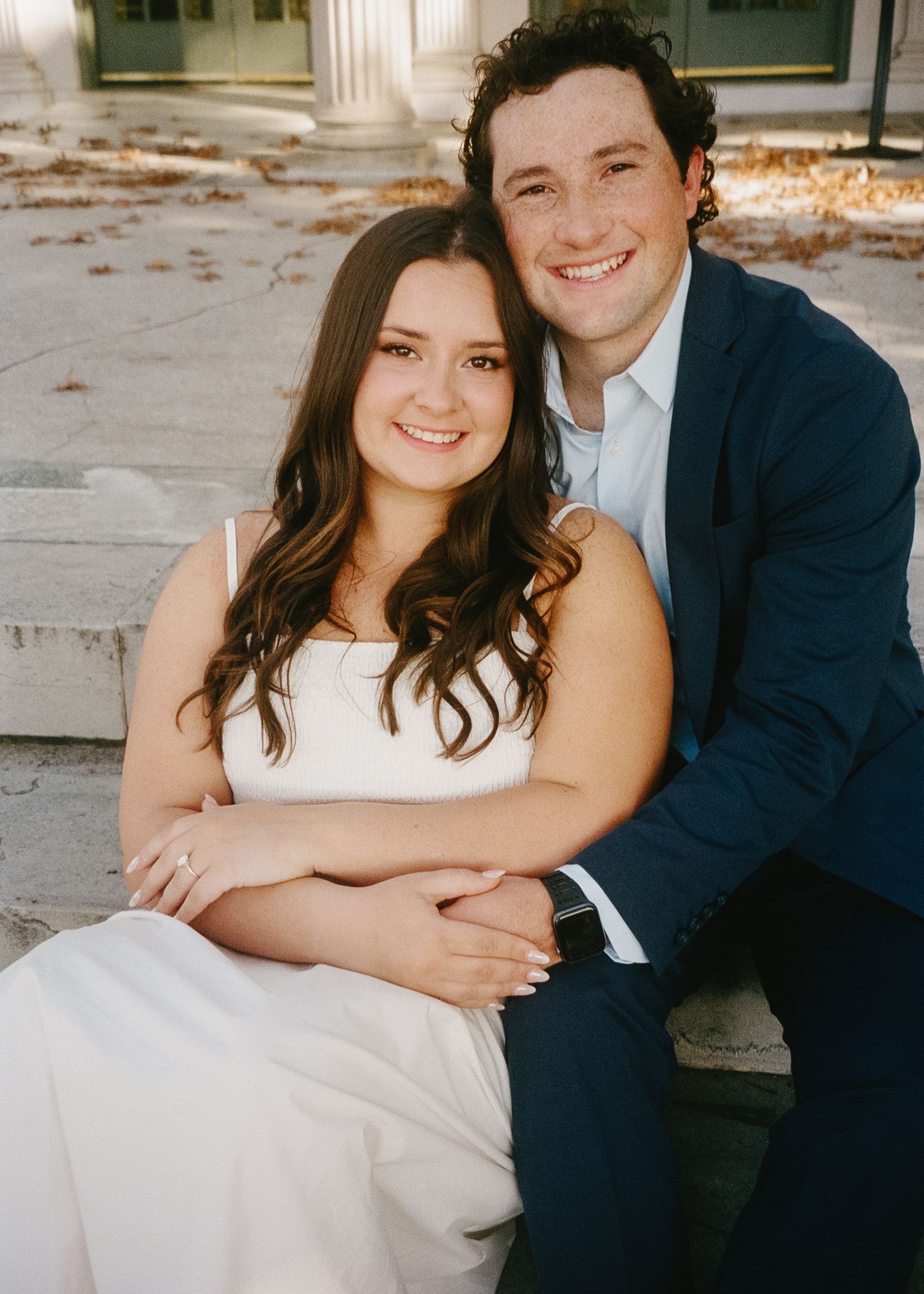 A couple in wedding attire share romantic moments in a series of four outdoor photos.